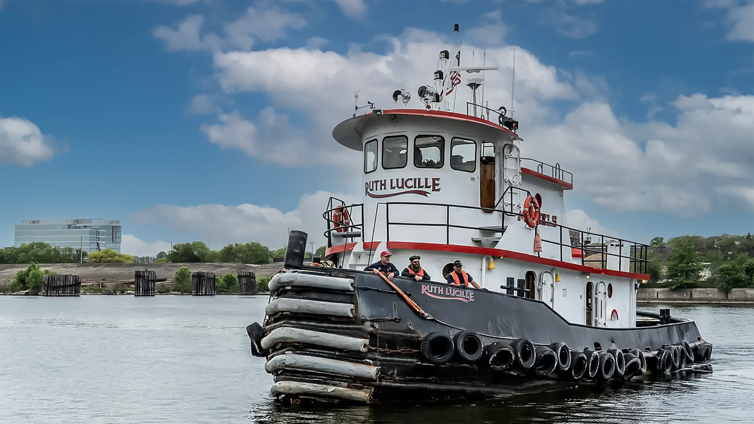 Crew members ride in Michels Ruth Lucille tugboat