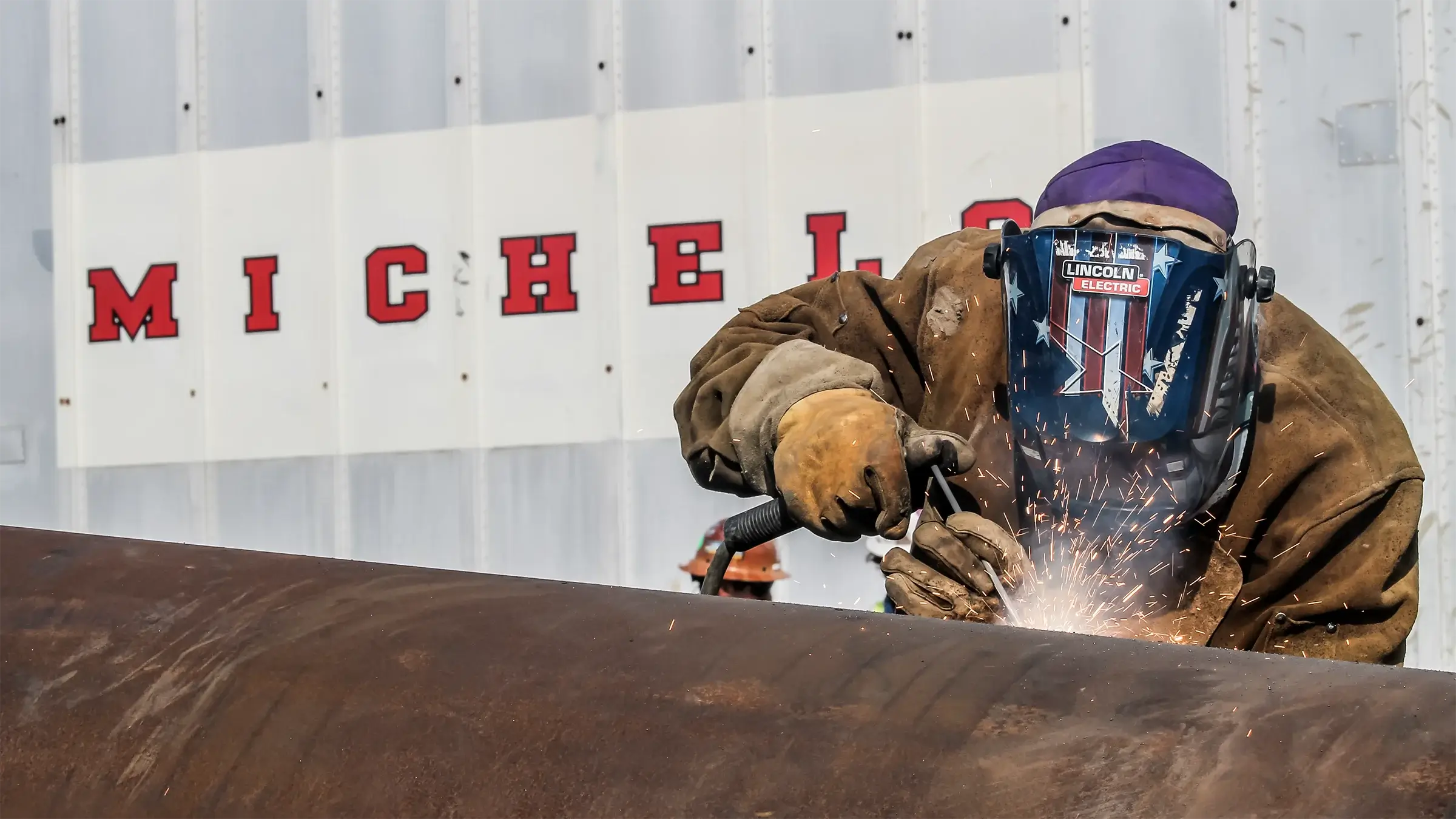 Person welds a large pipe