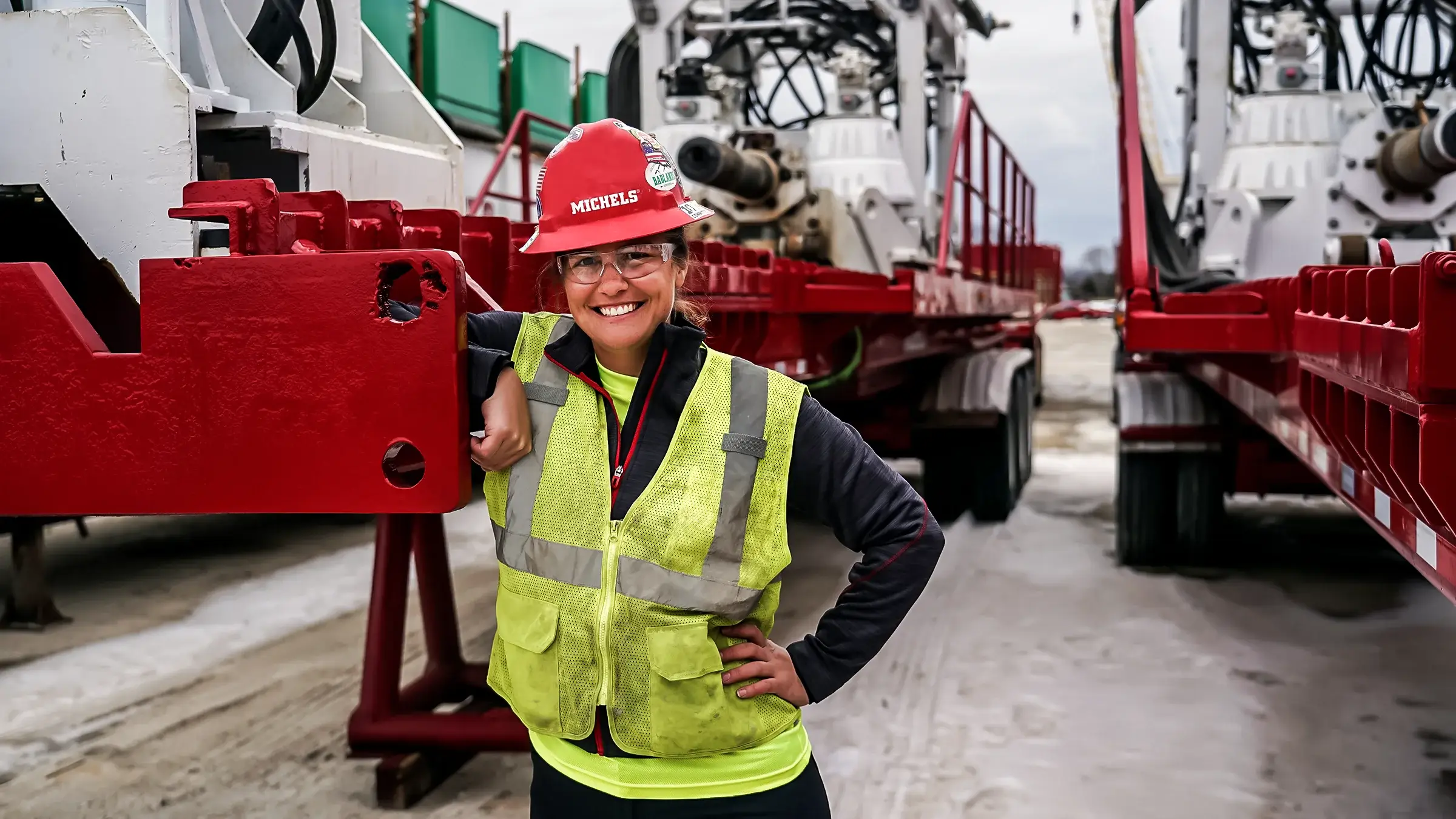 A woman stands next to a drill rig
