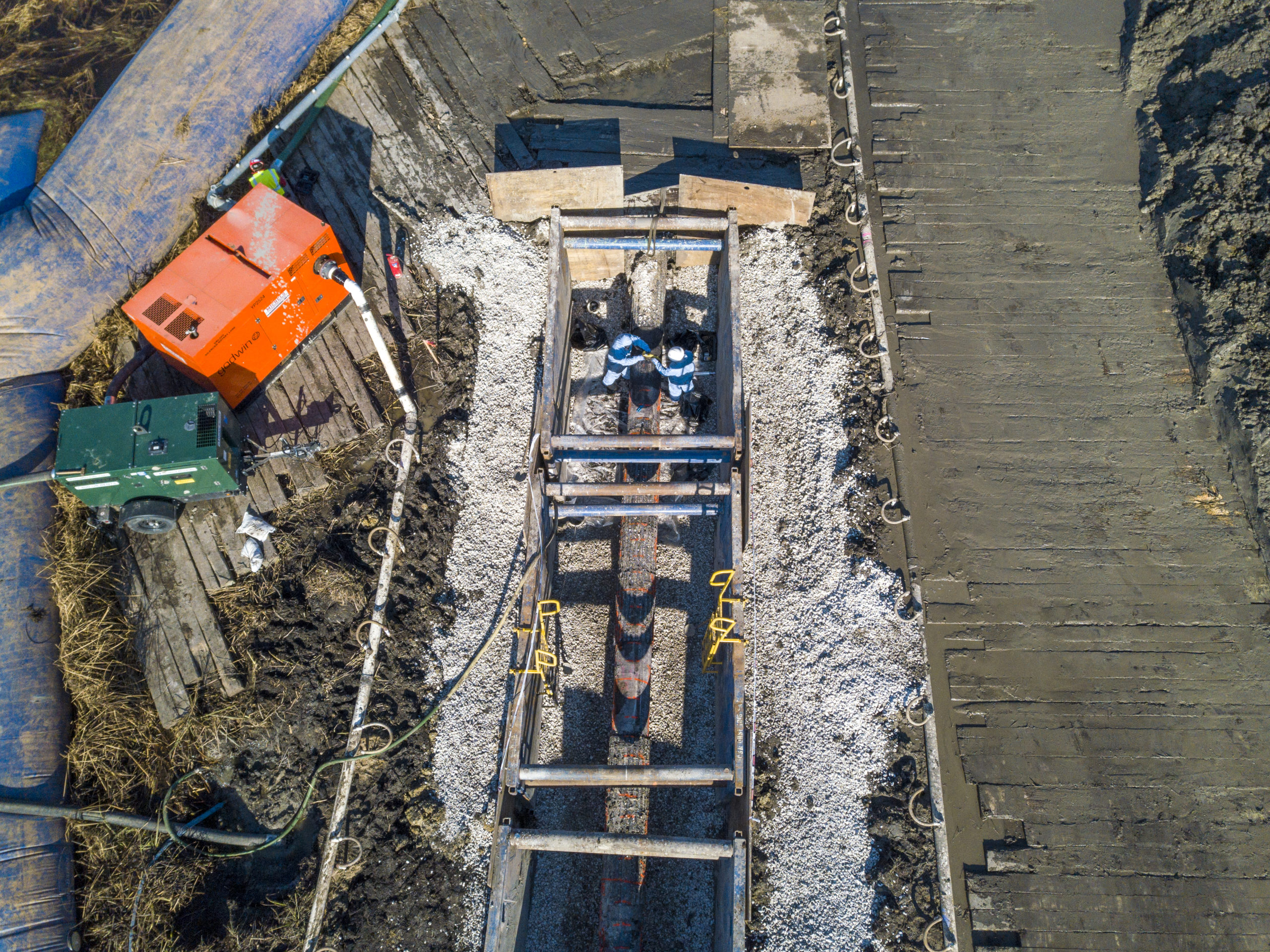 Crew works to recoat pipeline in trench