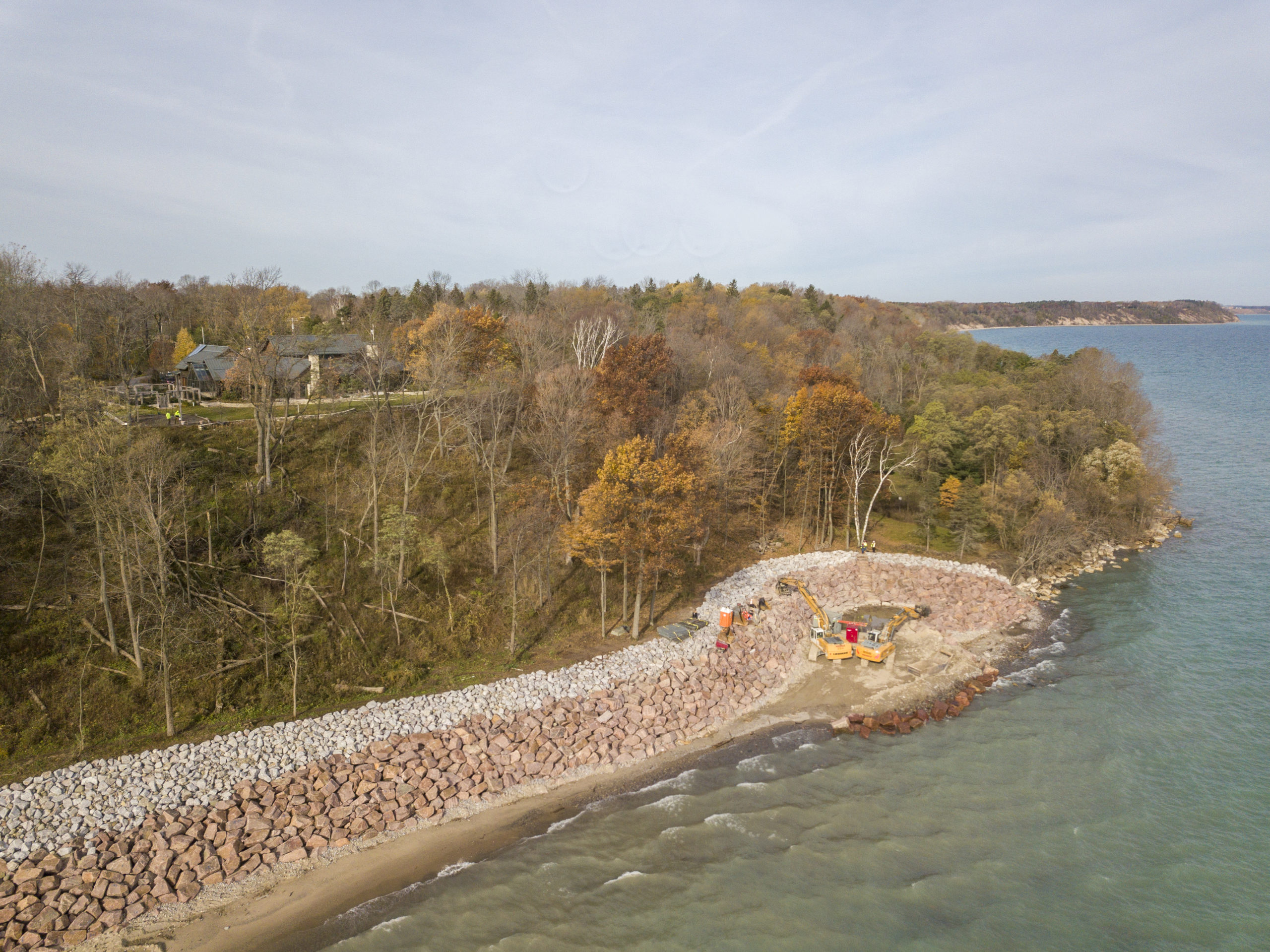Excavators install new stone to prevent erosion on the Lake Michigan shoreline