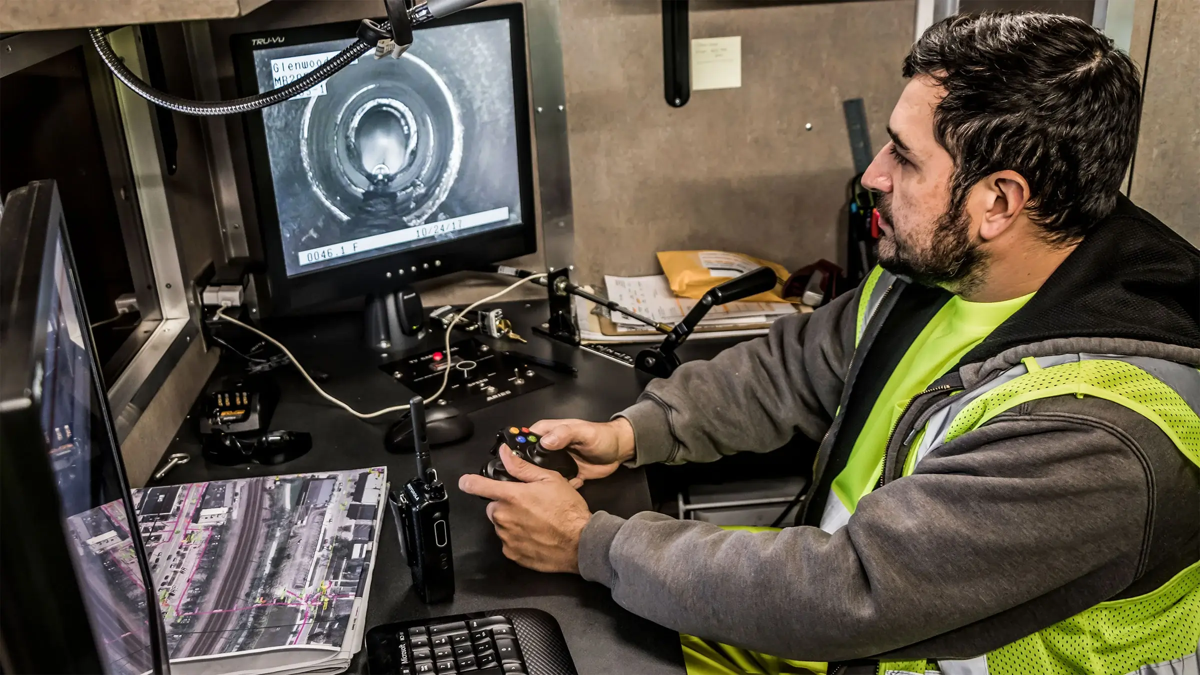 An operator uses a remotely controlled camera to document the conditions of a sewer