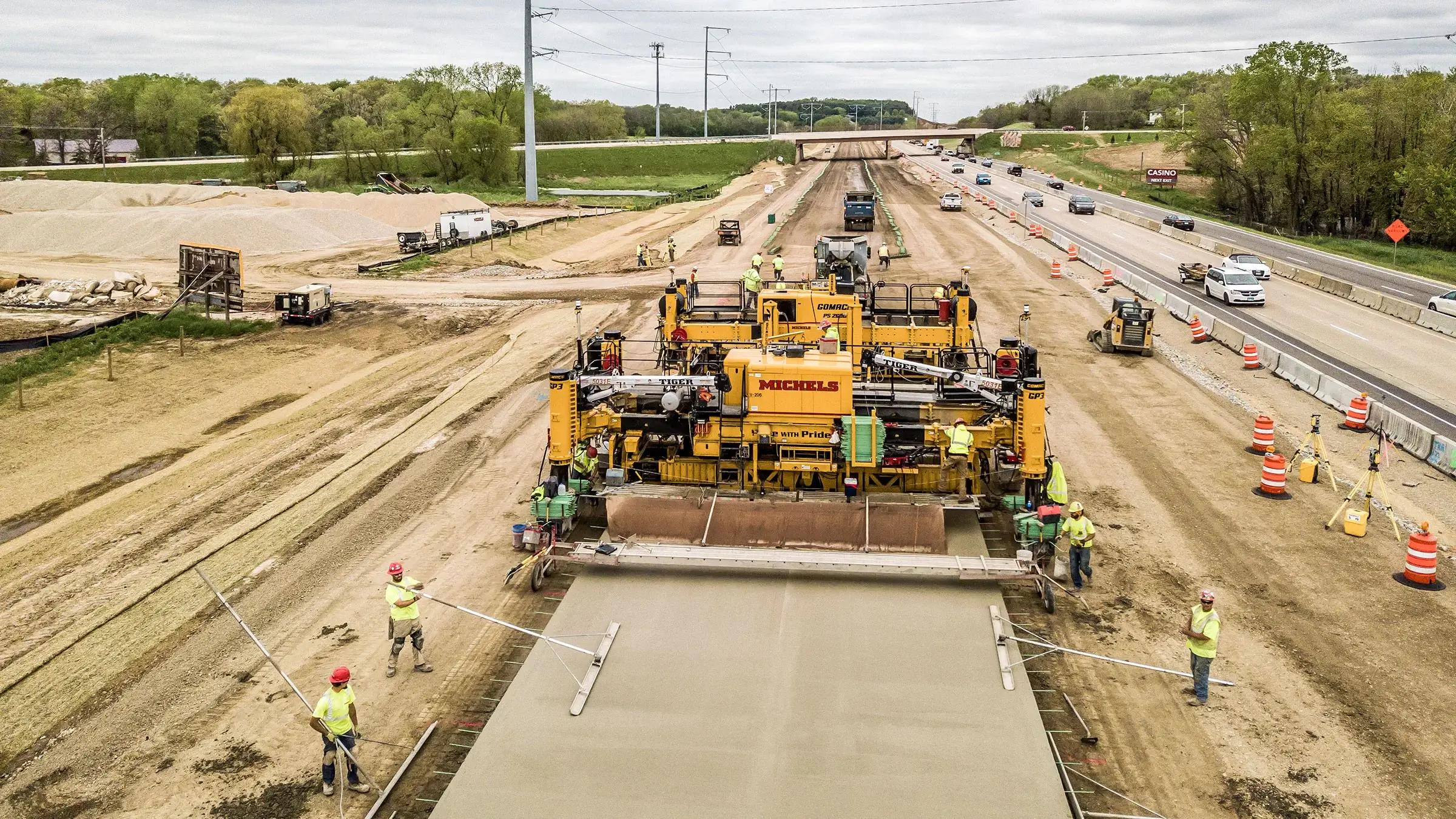 A Michels Road & Stone crew operate a paving machine on Interstate 39
