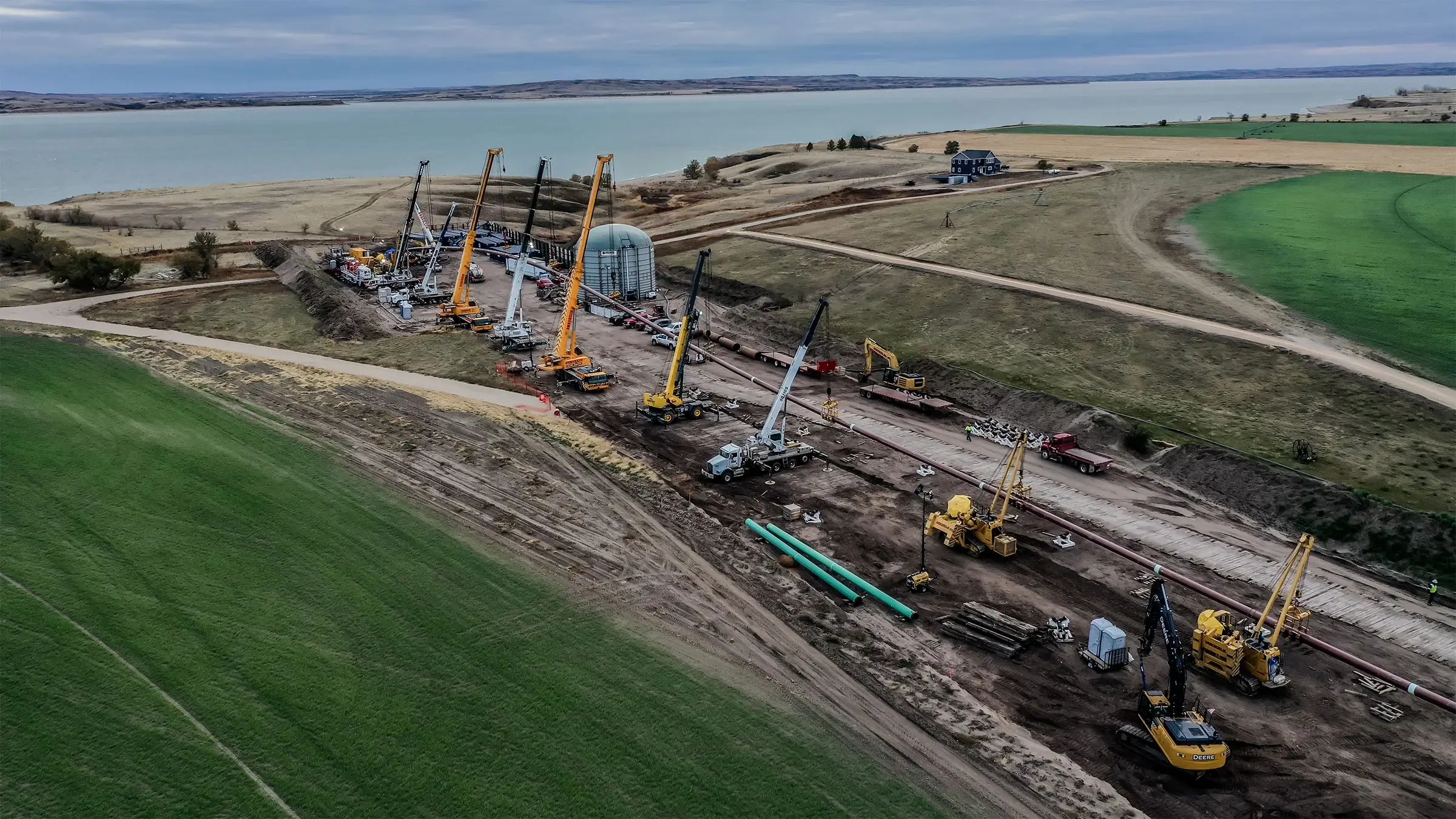 A long line of pipe is pulled into place under Lake Sakakawea