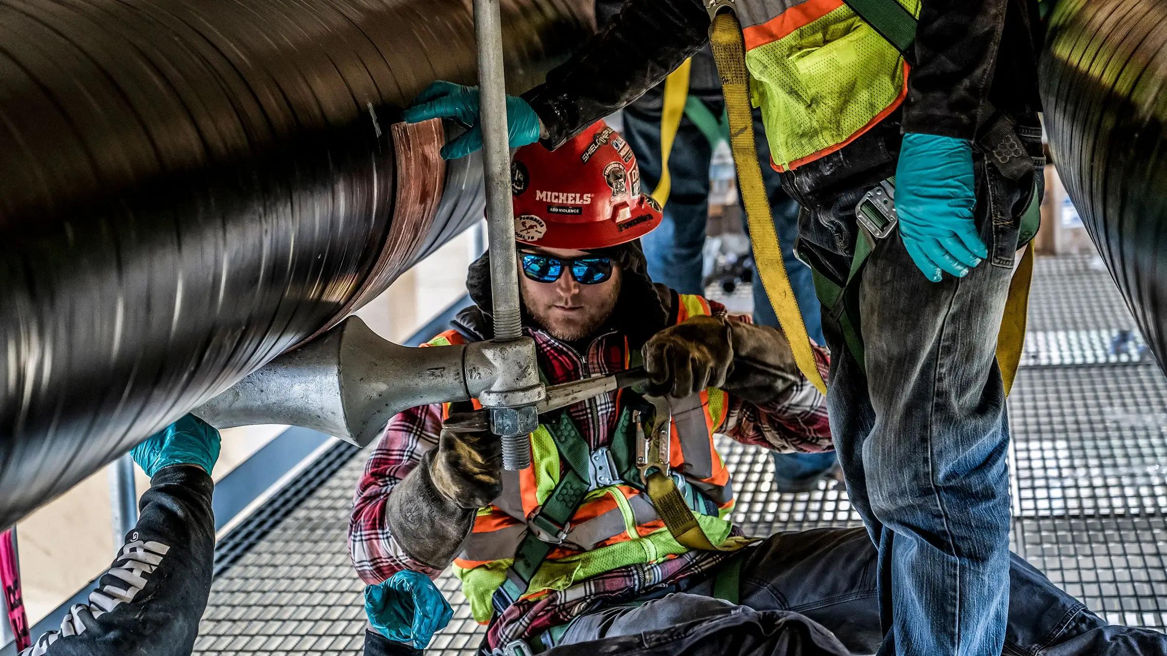 Michels Utility Services crew fastens natural gas pipelines under bridge in Minneapolis Minnesota