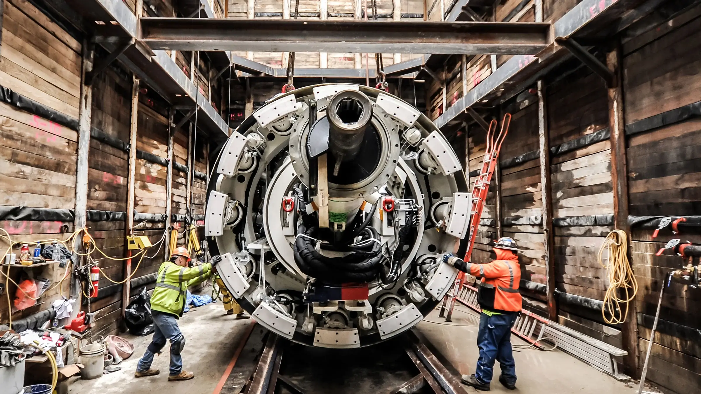 Crew performing maintenance check on 12-foot diameter earth pressure balance tunnel boring machine
