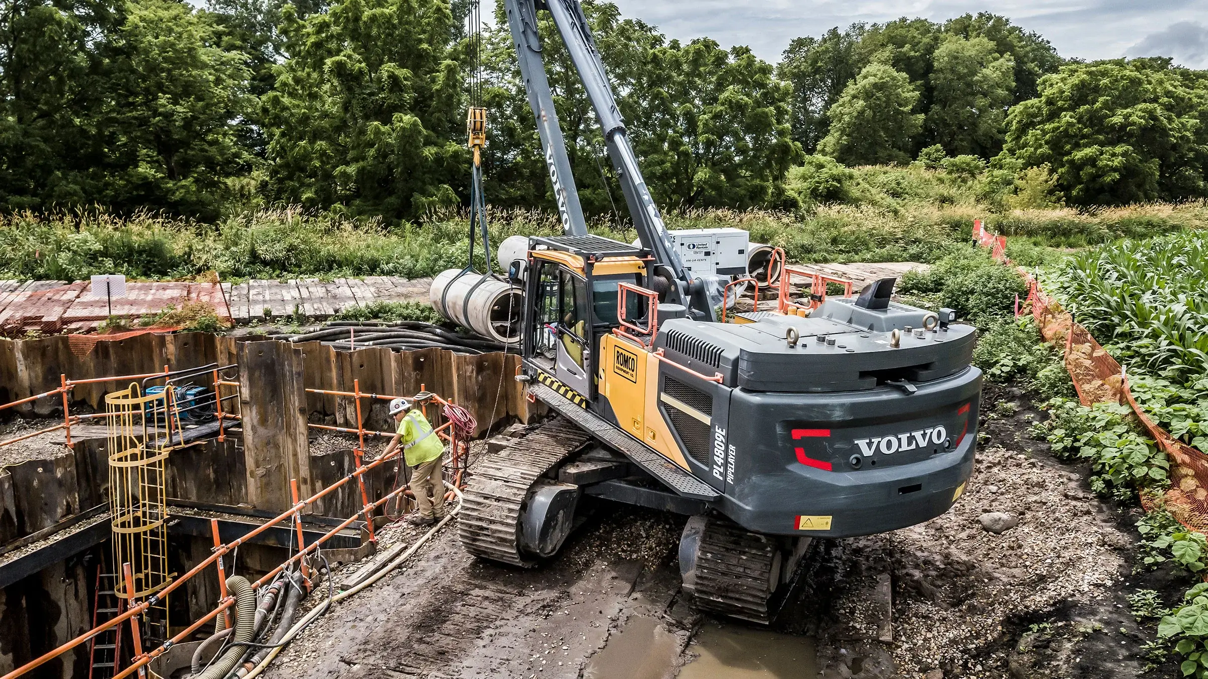 Excavator begins to install reinforced concrete pipe under the Hennepin Canal