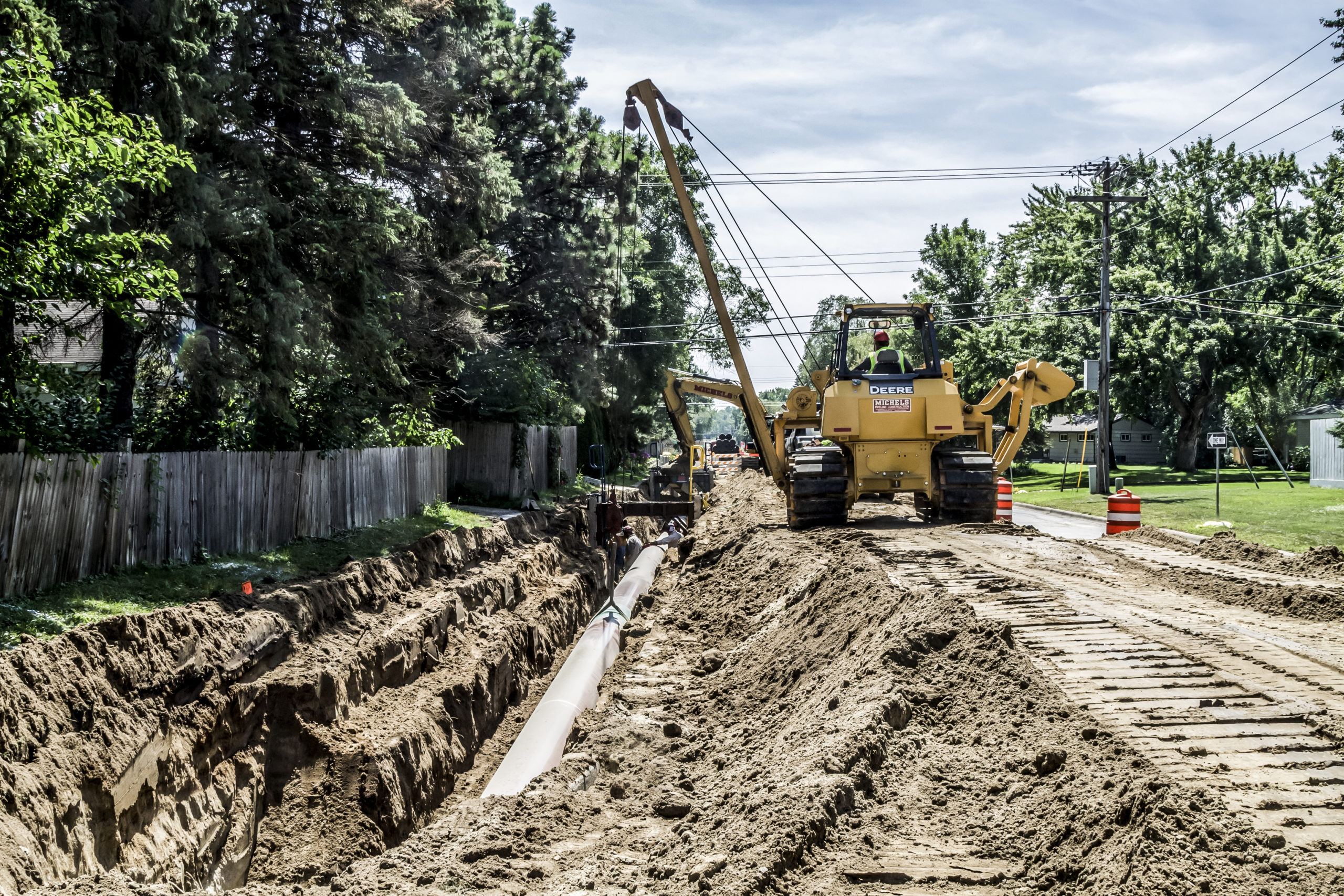 Sideboom places natural gas transmission pipeline into place in a Minnesotan suburb