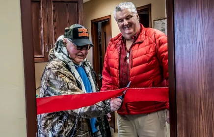 Pat Michels and Jerry Eilbes ribbon cutting to a new conference room.