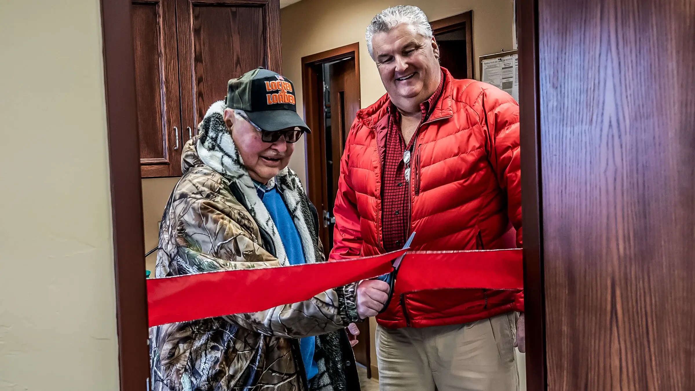 Pat Michels and Jerry Eilbes ribbon cutting to a new conference room.