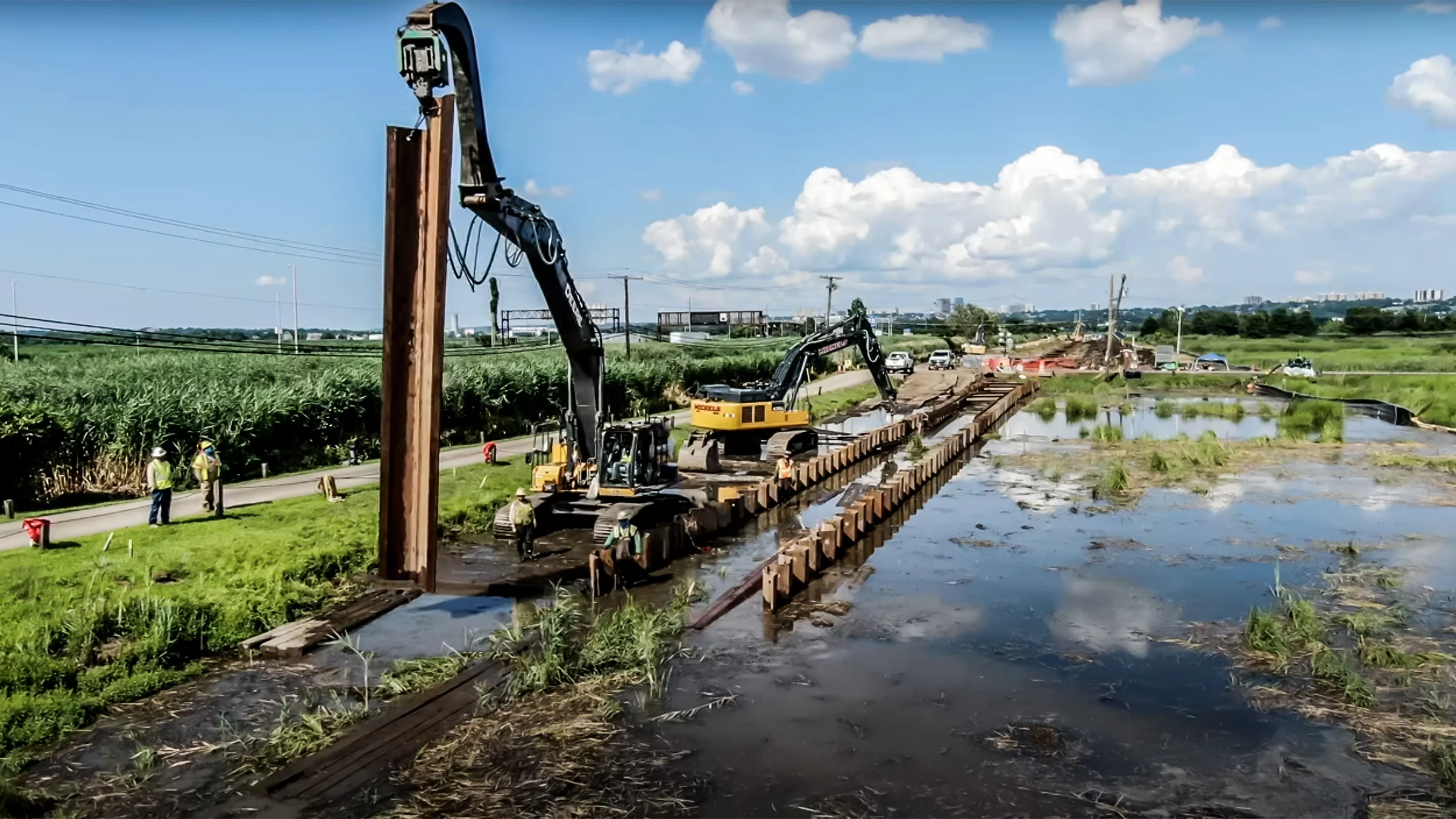 Pipeline maintenance underway in wet land.