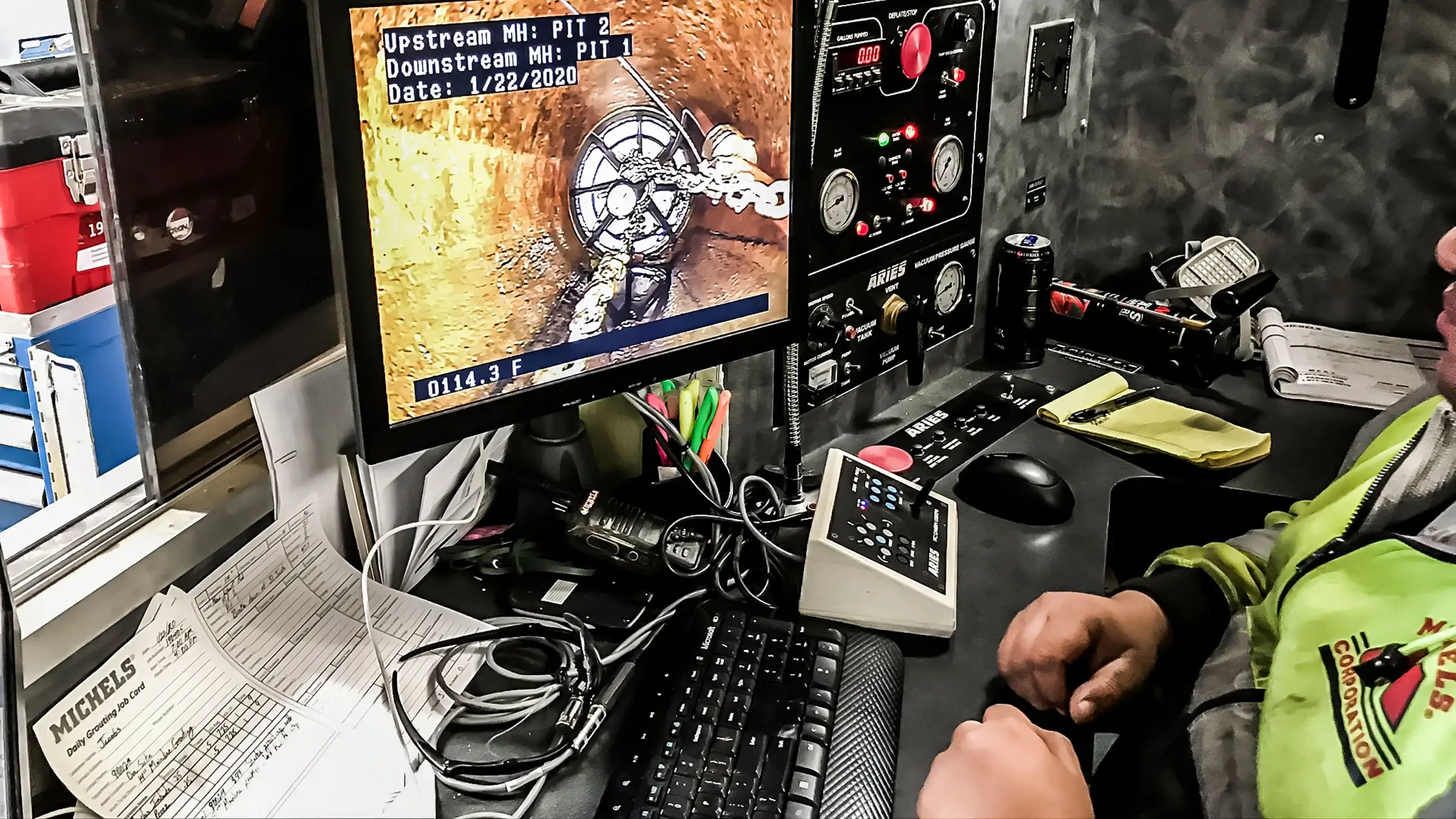A crew member observes a sewer rehabilitation job from a monitor