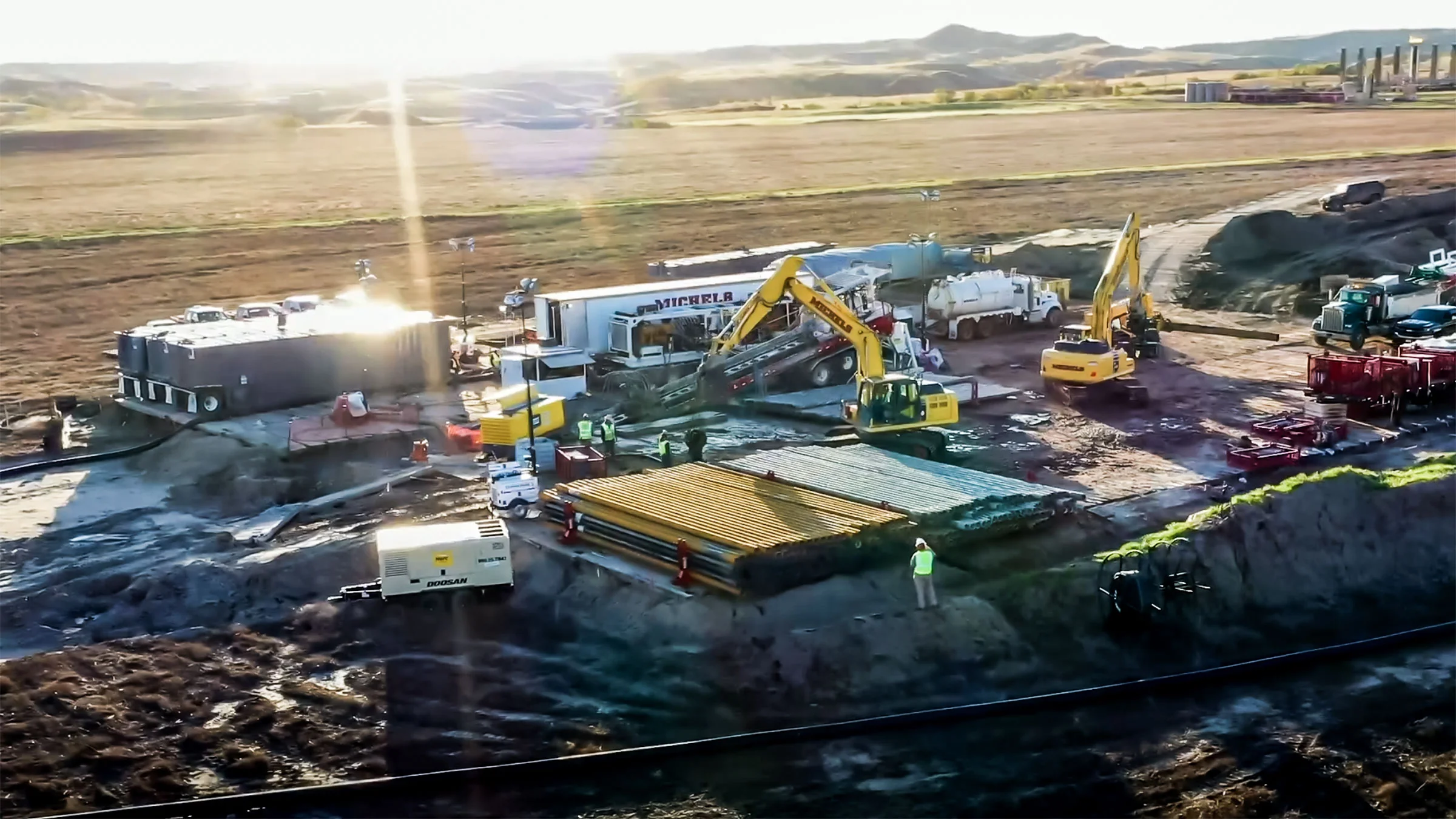 A brilliant sun rises over a Michels Trenchless jobsite.