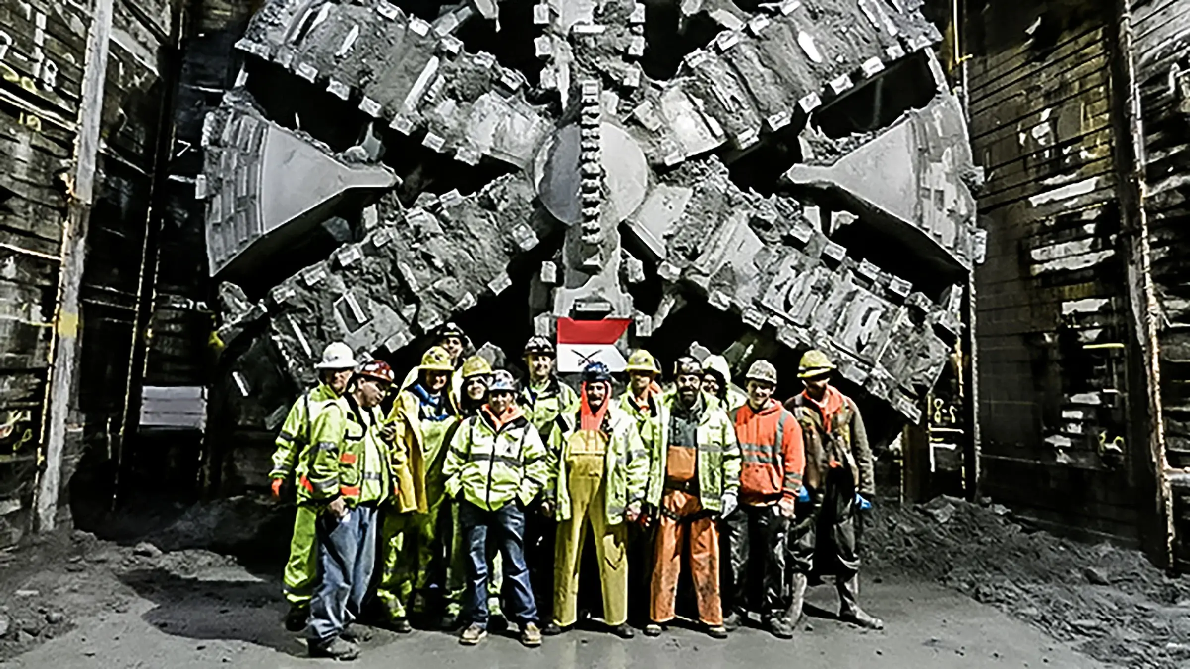 Crew stand for a photo in front of the University Link light rail extension project.