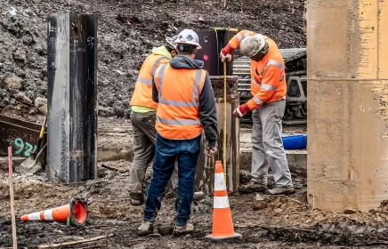 Three Michels crew members measure and adjust a foundations shaft