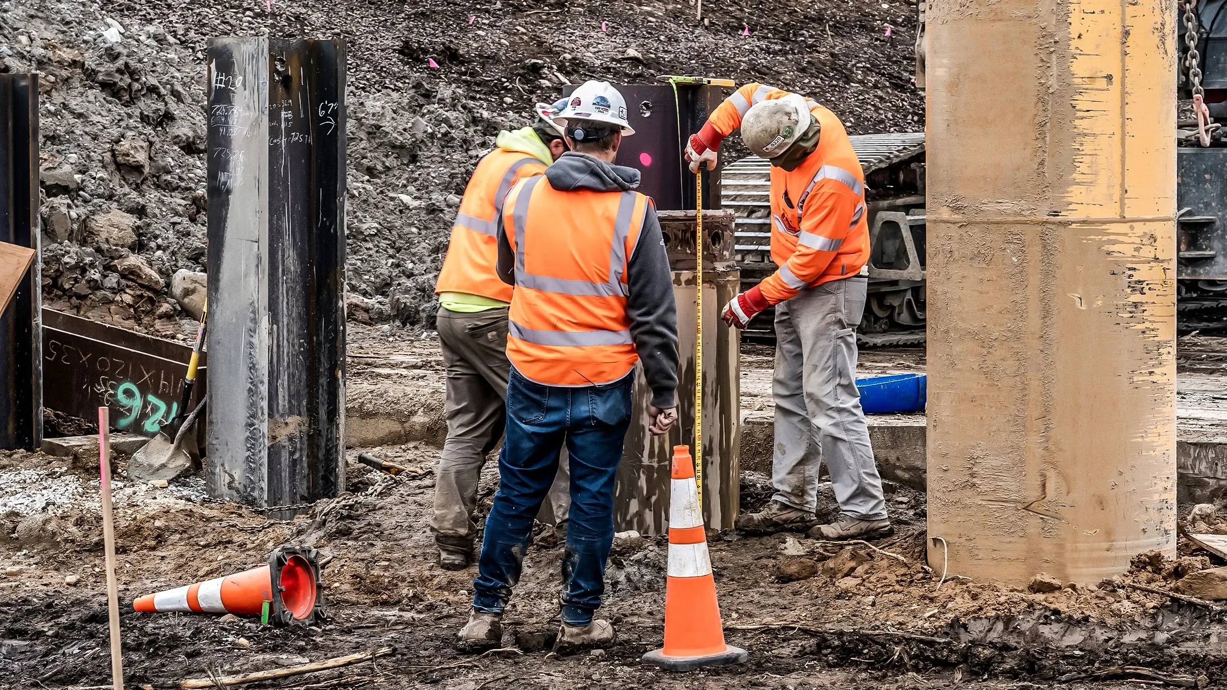 Three Michels crew members measure and adjust a foundations shaft