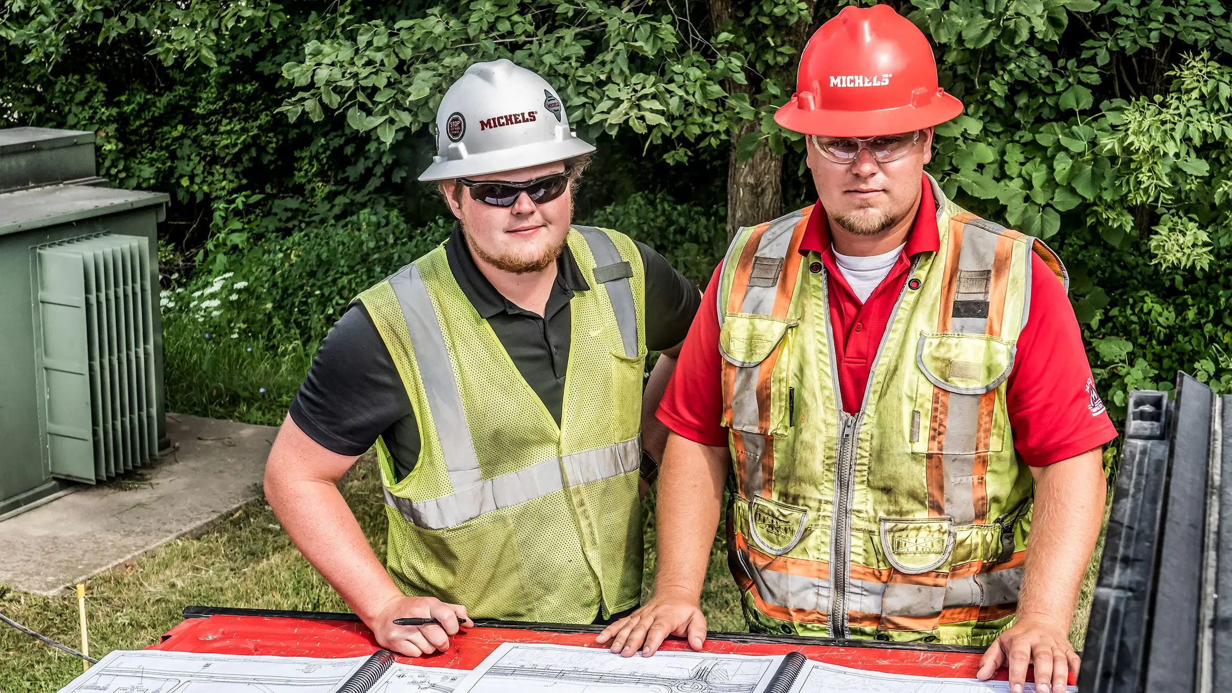 An intern and foreman start around work plans on site.