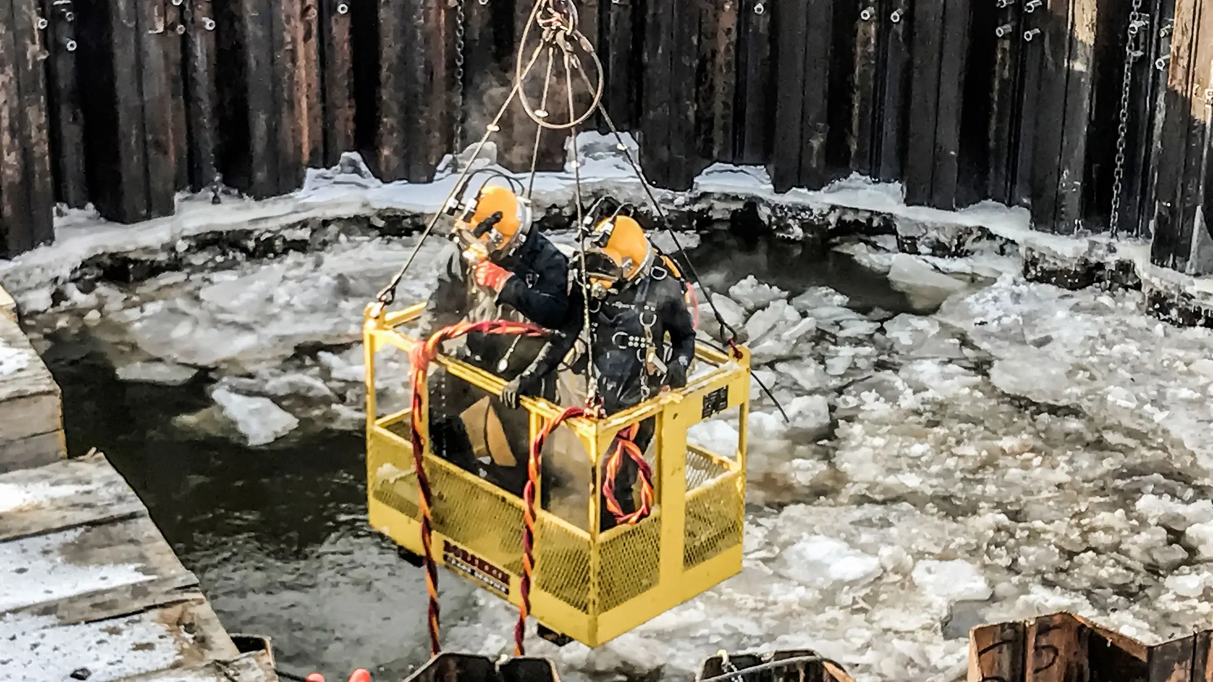 Marine divers on Coffer Dam in a cage.