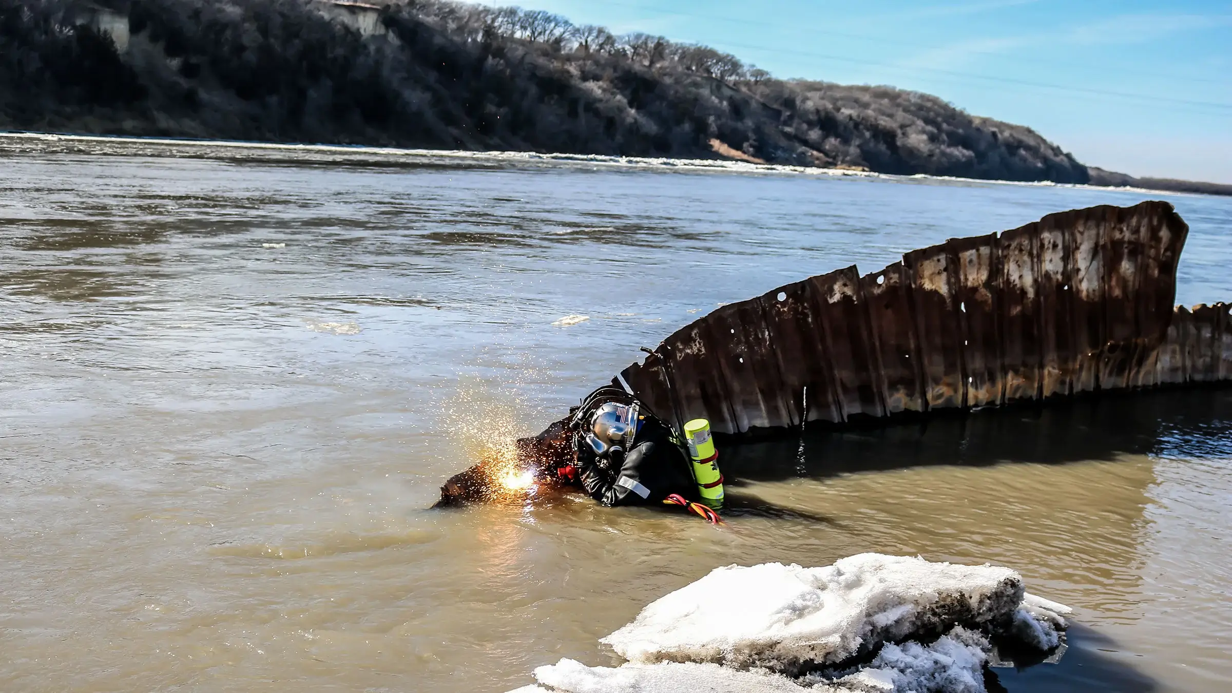 Marine divers are welding in a river.