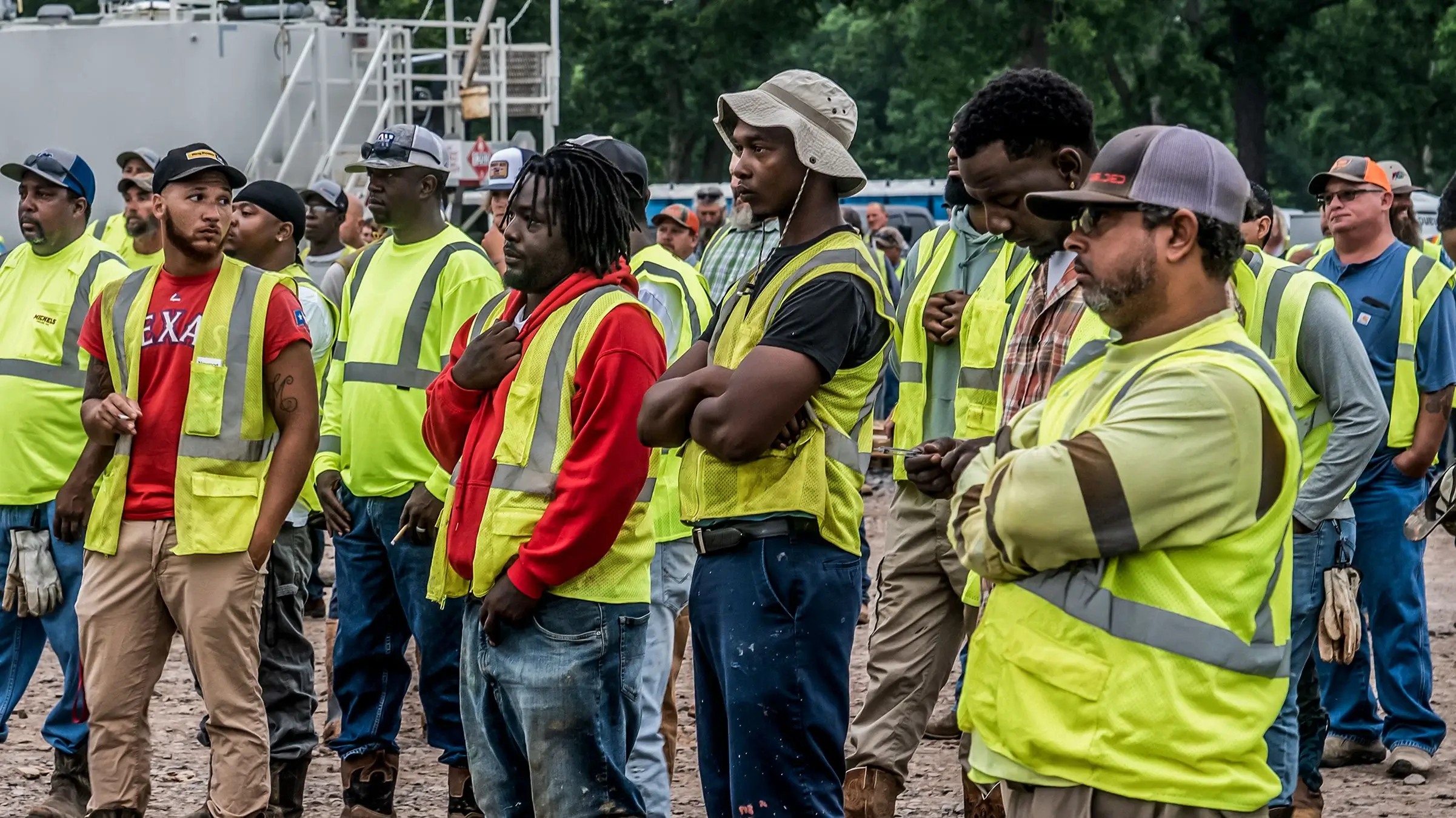 Members of a pipeline crew listen to a safety briefing prior to beginning work.