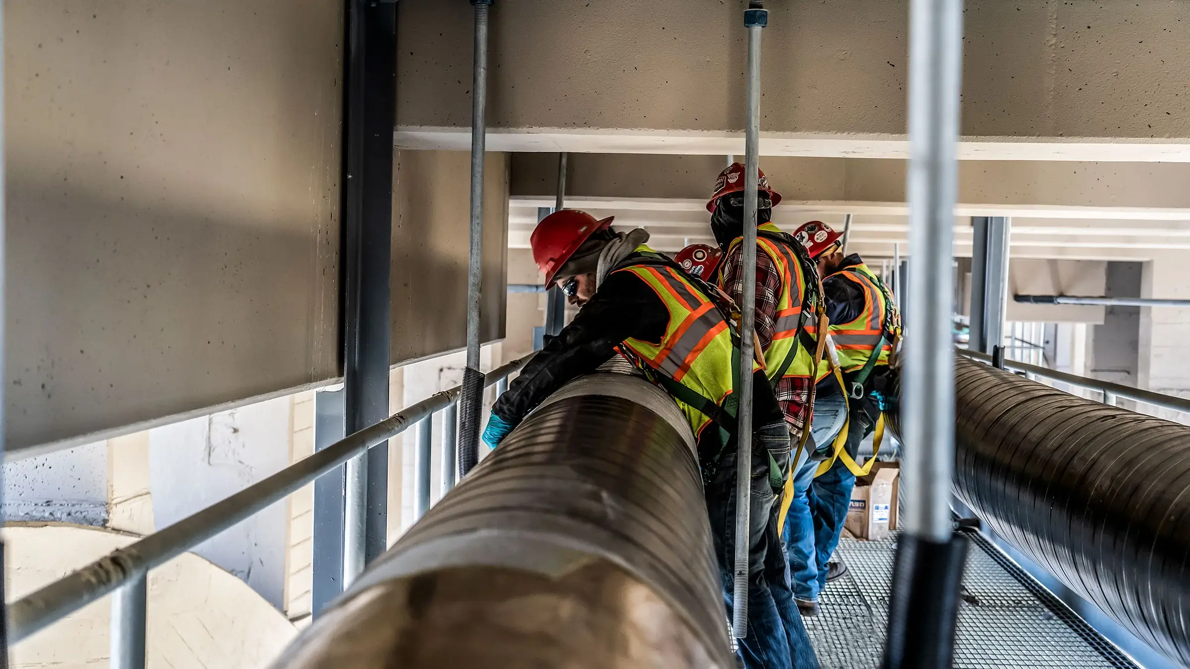 Michels Utility Services employees work under a bridge to install gas pipelines.