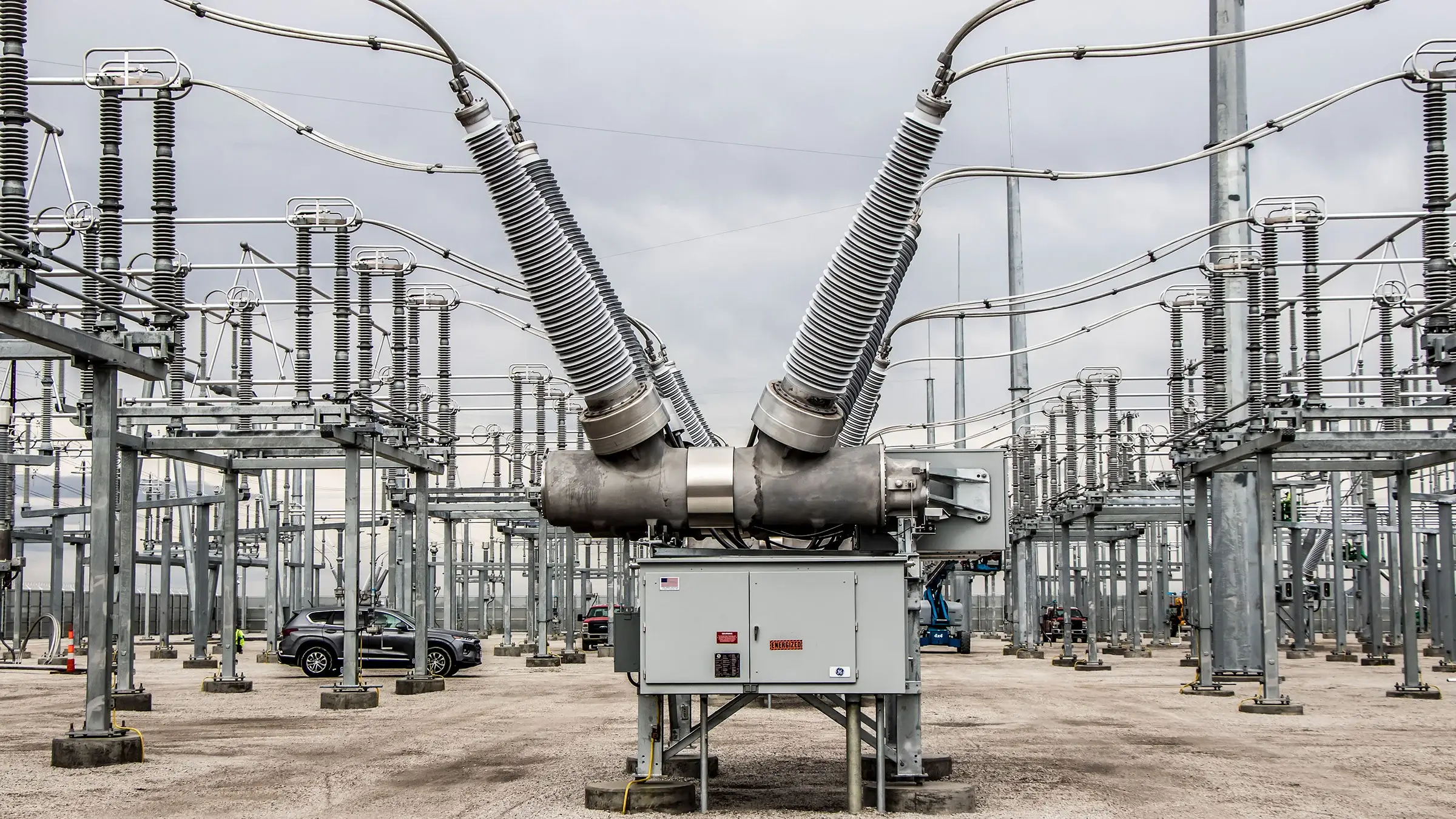 A transformer sits inside a large substation