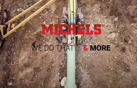 Aerial view of pipeline with Michels logo and slogan overlay