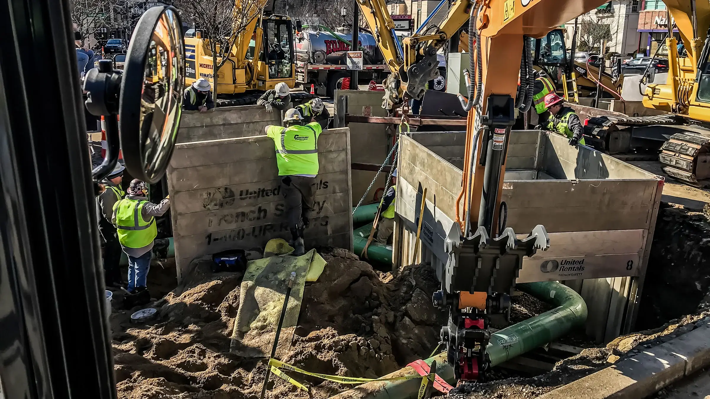Several trenches being installed in a busy urban environment