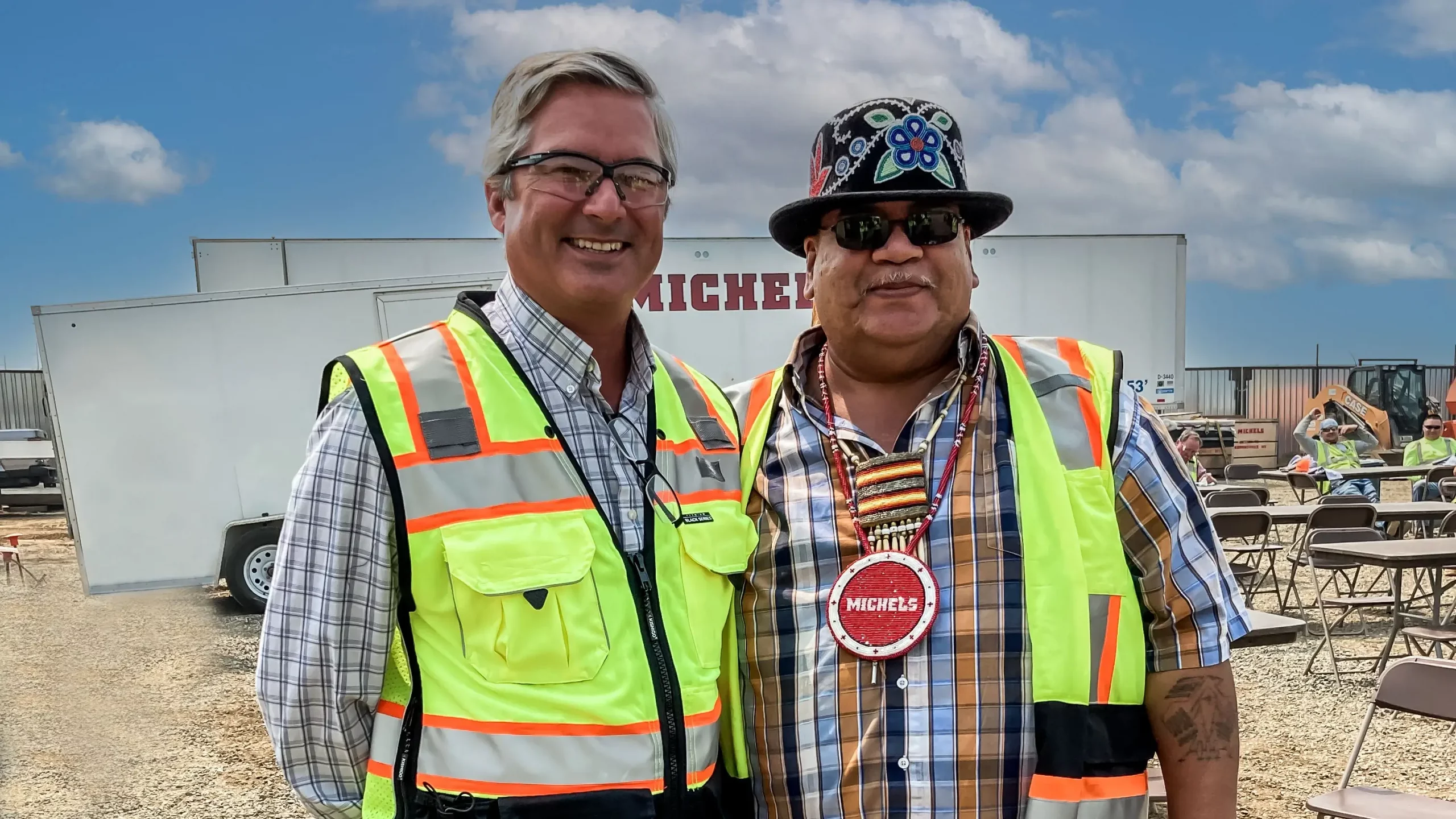 Bob Osborn stands with employee at work lunch event