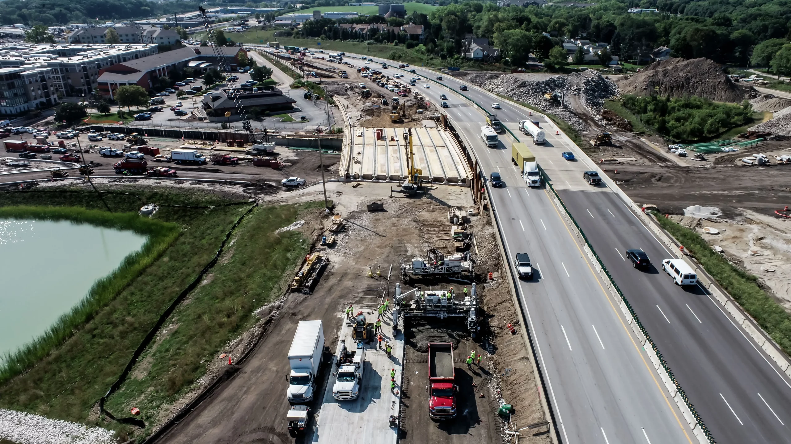 Aerial photo of crew working on repaving a very busy highway system.