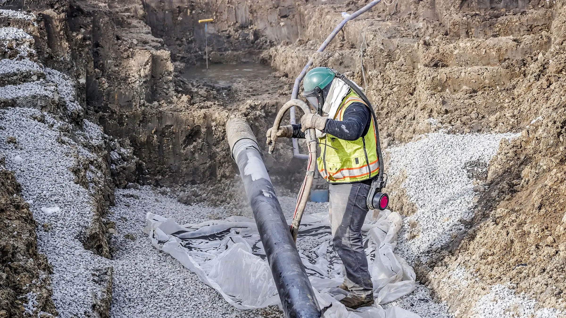 A Michels crew member performs a sleeve operation job on a portion of pipe