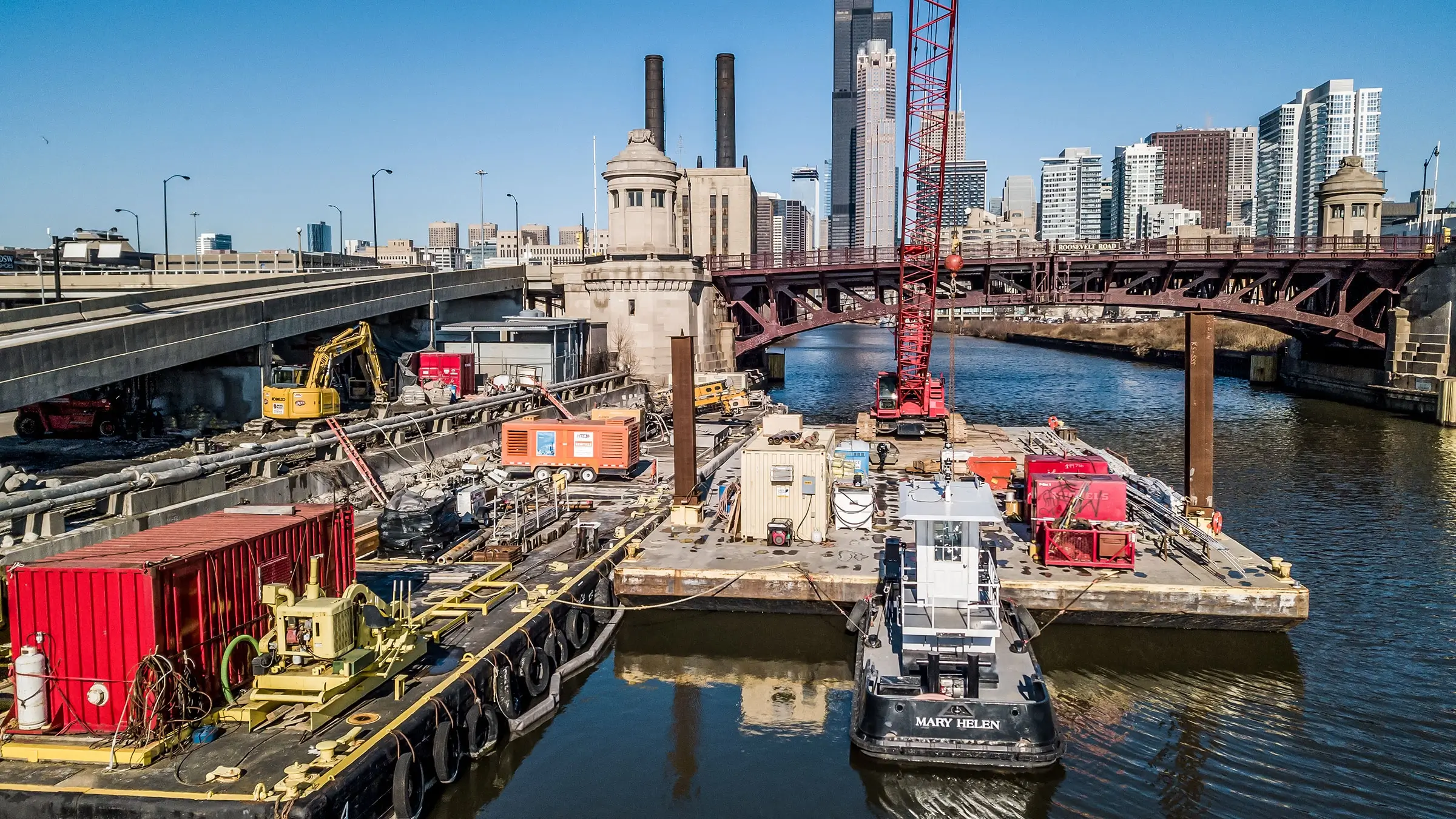 Excavator works from barge to reconstruct seawall on Chicago River