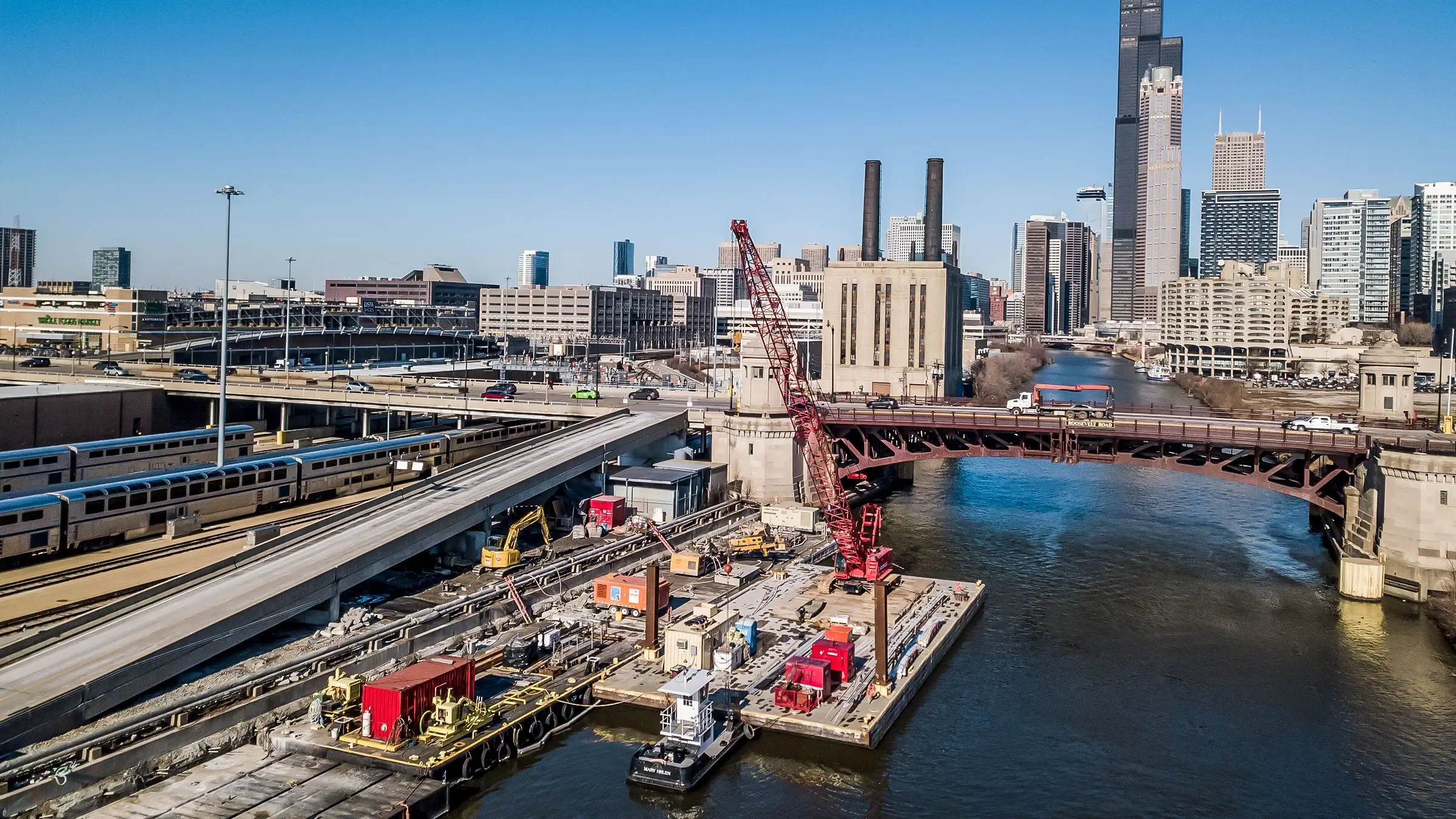 Excavator works from barge to reconstruct seawall on Chicago River