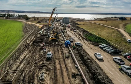 Aerial photo of a horizontal directional drilling project showing cranes ready to assist in placement of the HDD.