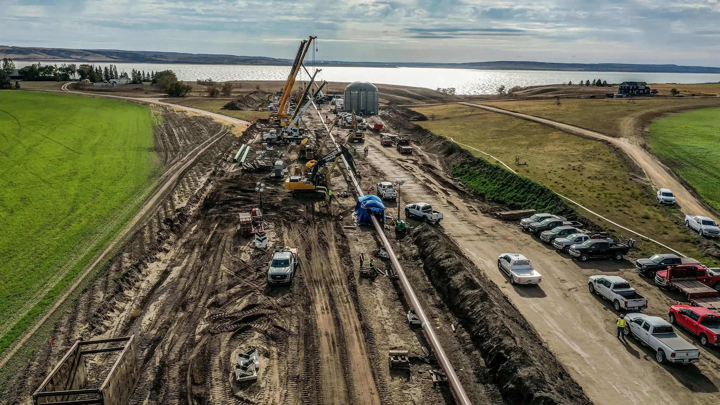 Aerial photo of a horizontal directional drilling project showing cranes ready to assist in placement of the HDD.