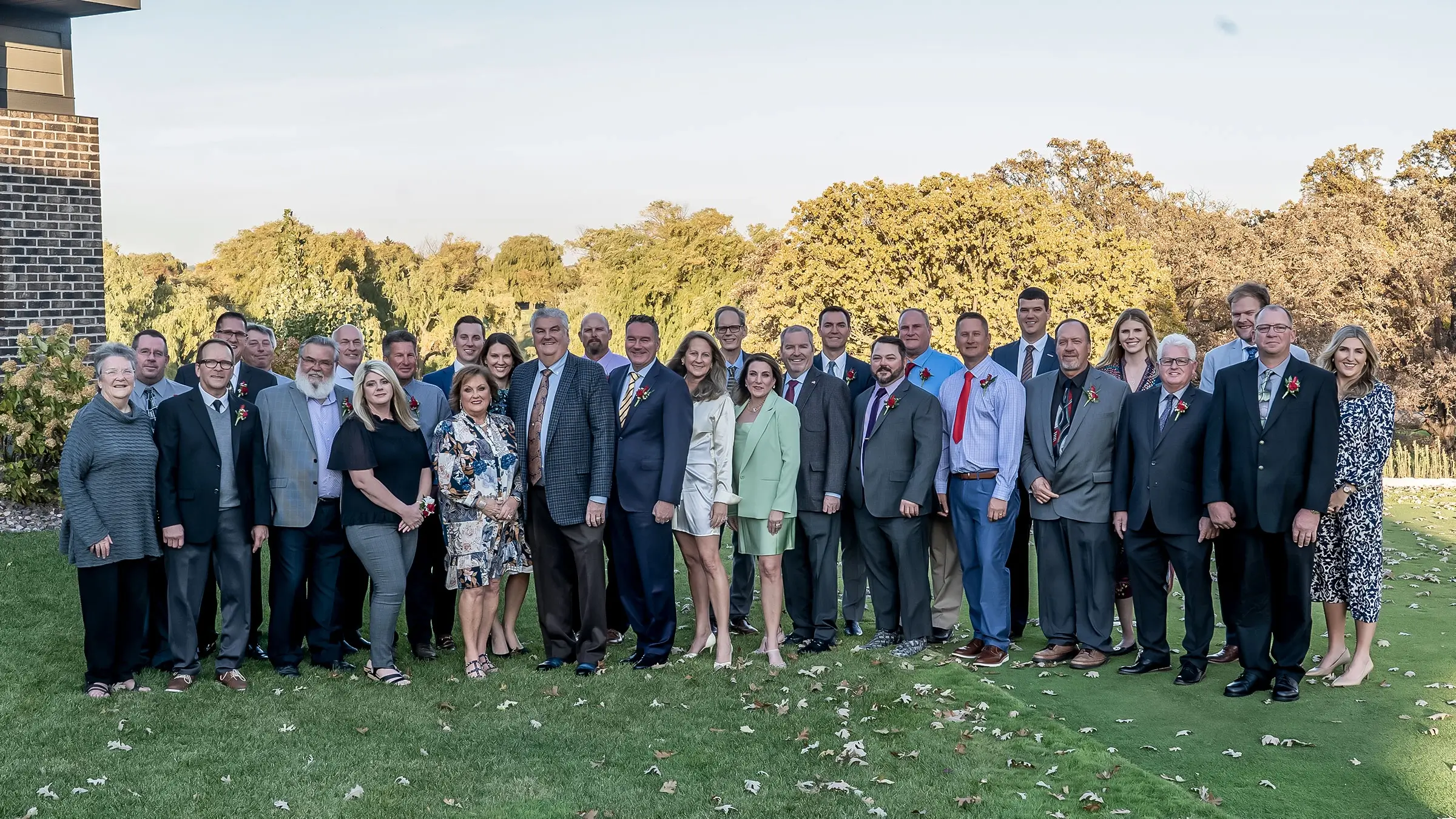 Employees who have been with the company for twenty five years join with the Michels family for a celebratory dinner and stand for a photo.