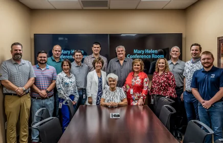 Group gathers in the new Mary Helen Conference room to celebrate.