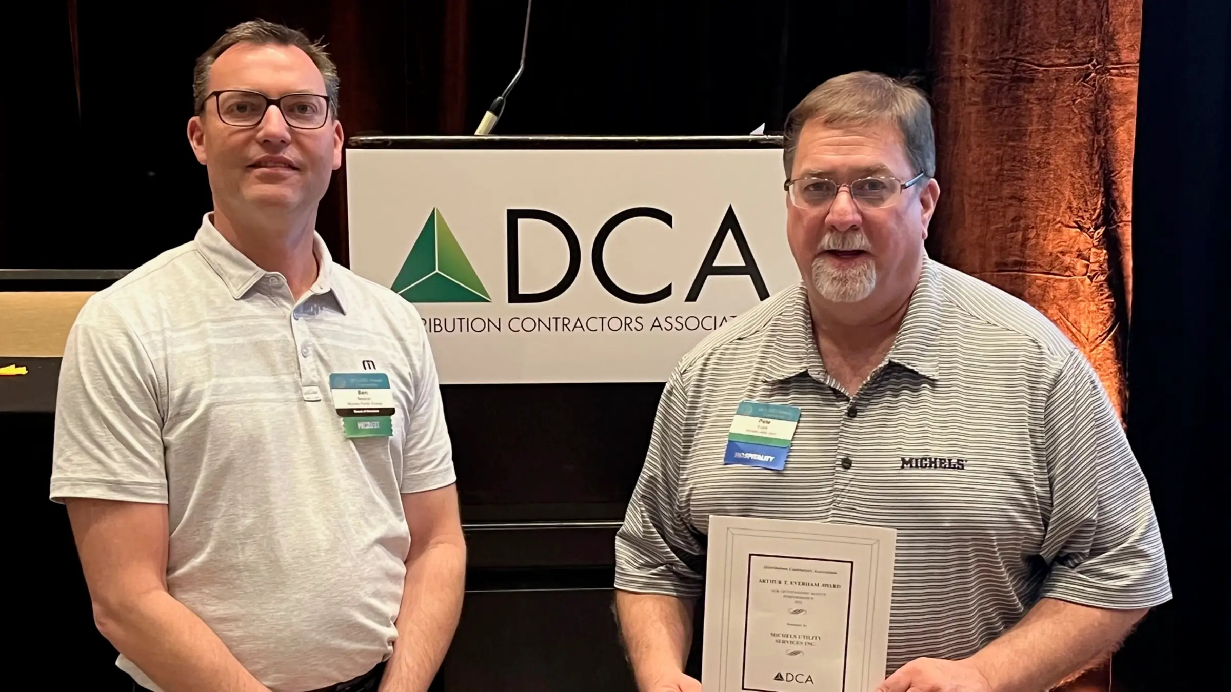 Michels Pacific Energy President Ben Nelson presents Michels Utility Services President Pete Fojtik with a DCA Safety Award
