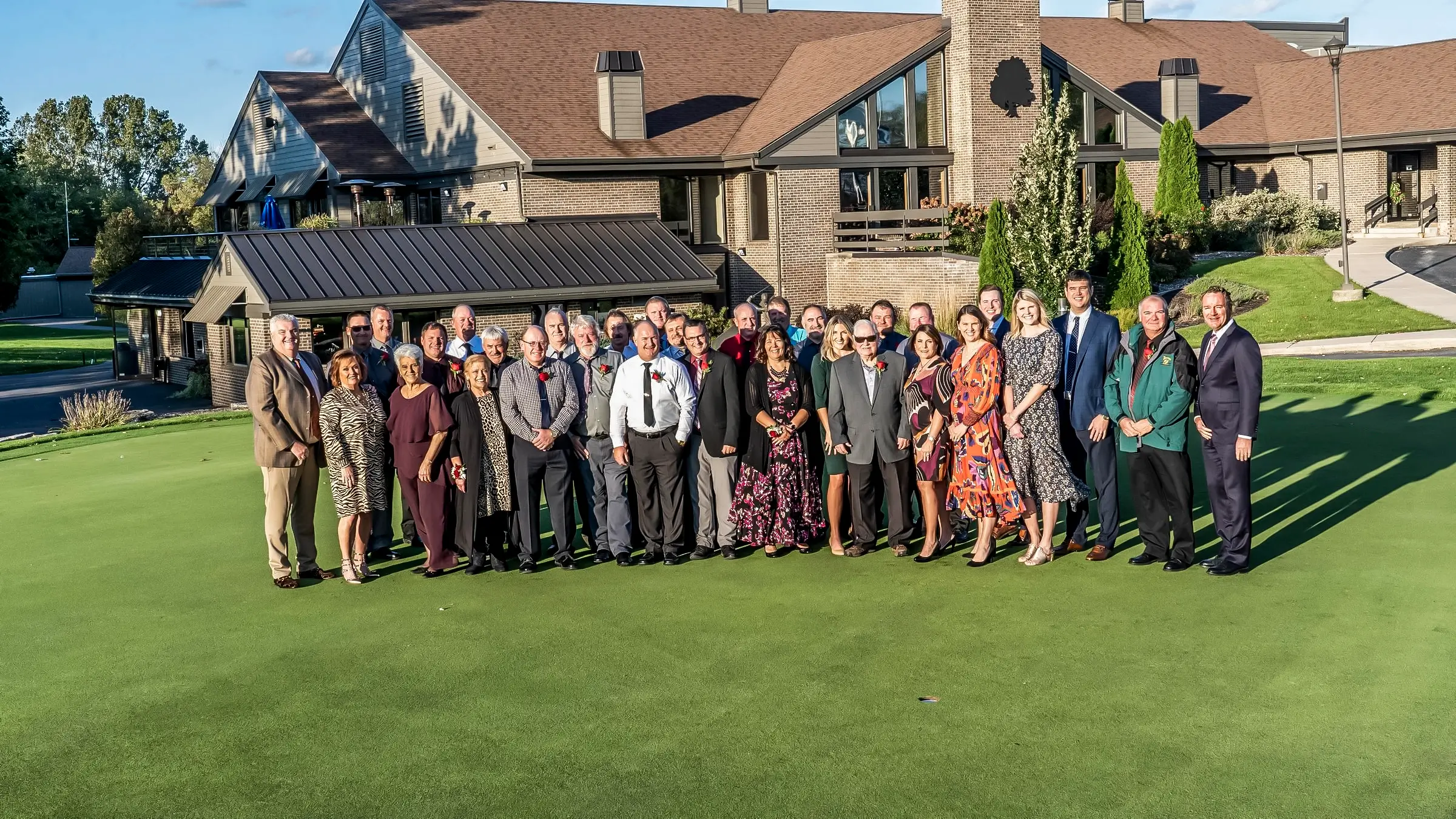 Group of Michels executives and employees standing outside of a country club