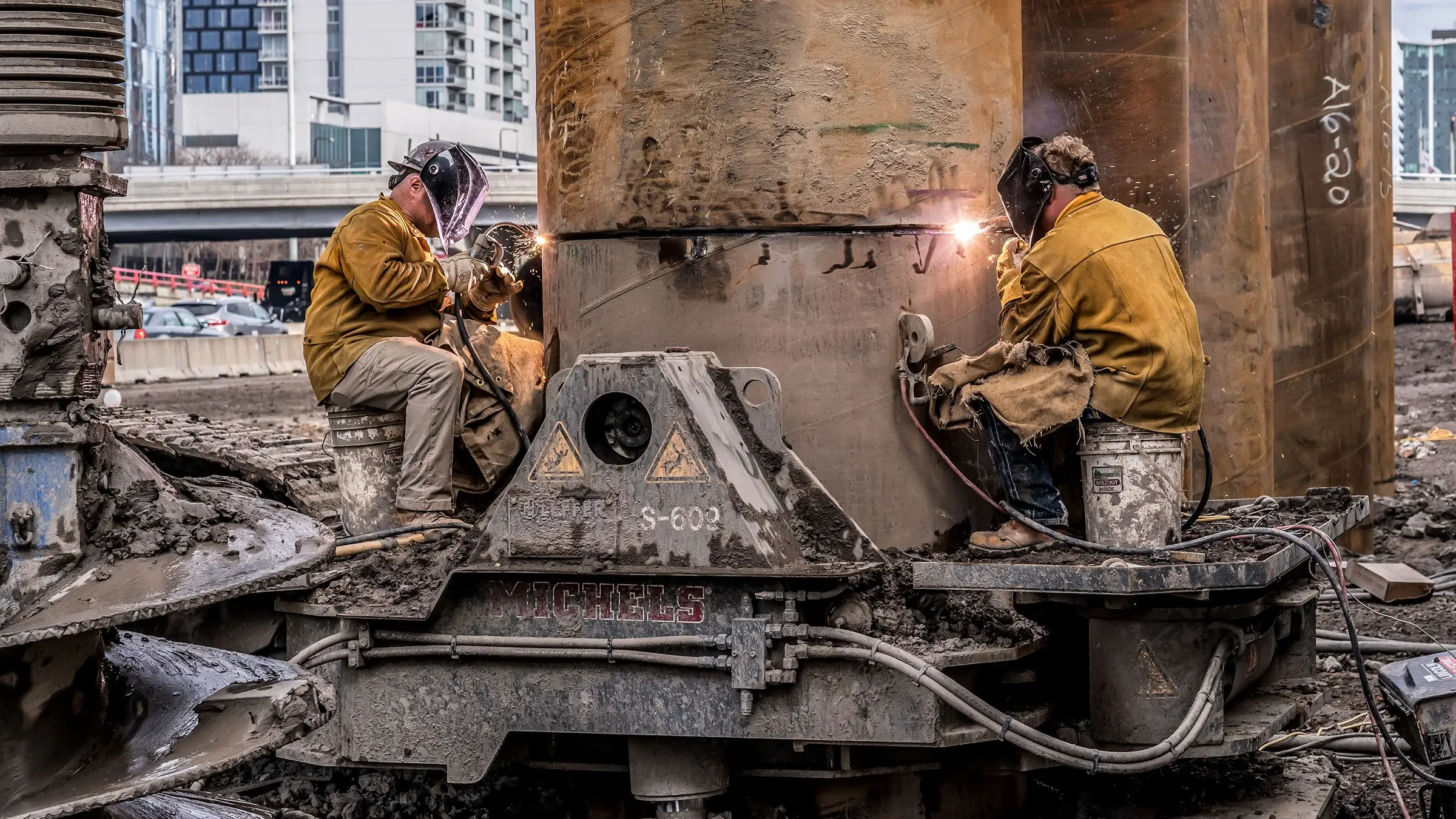 Two welders working on a jobsite on an oscillator