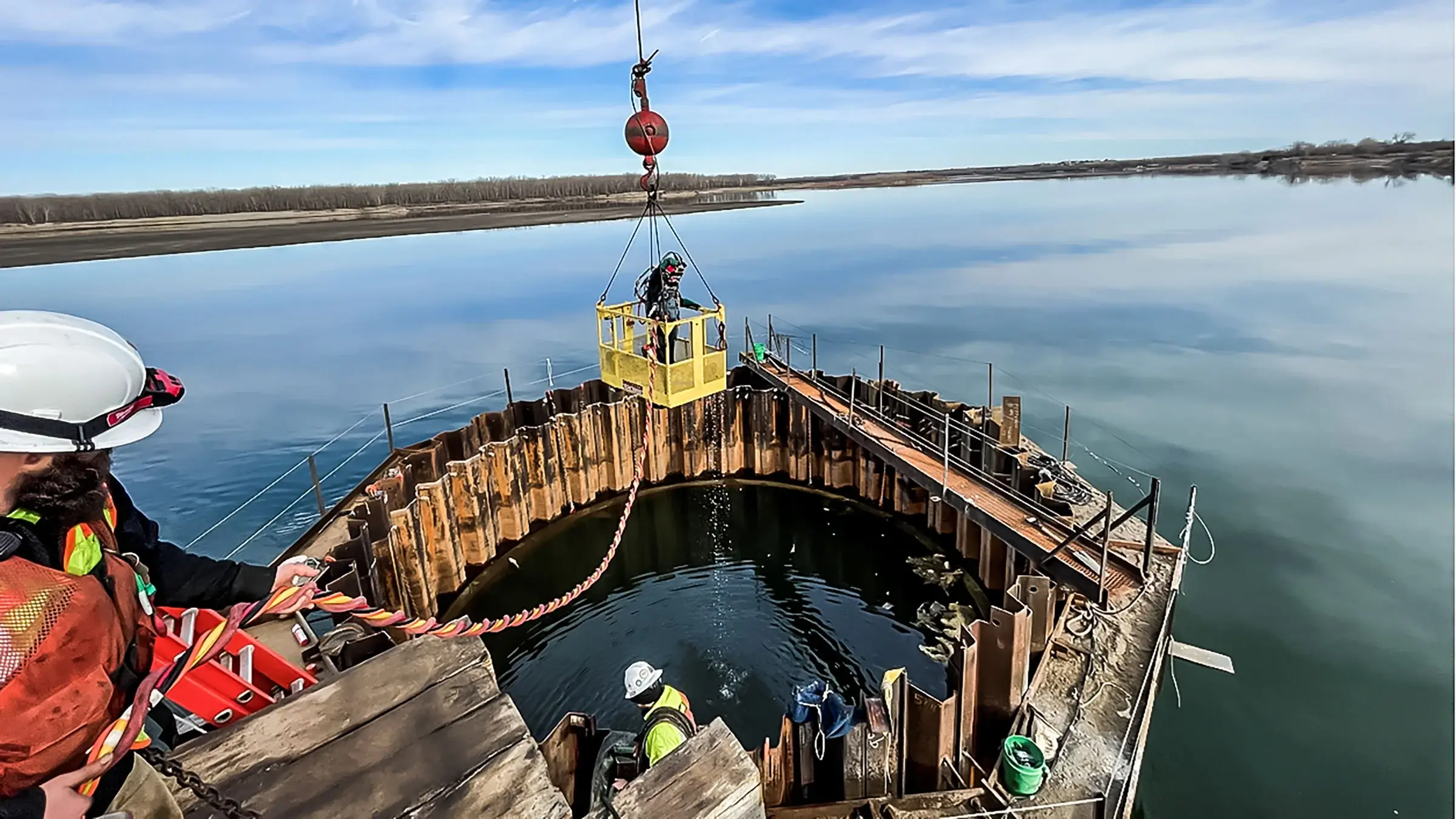 A diver is lowered into a marine job site