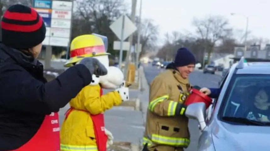 Employees gather donations on the side of the road