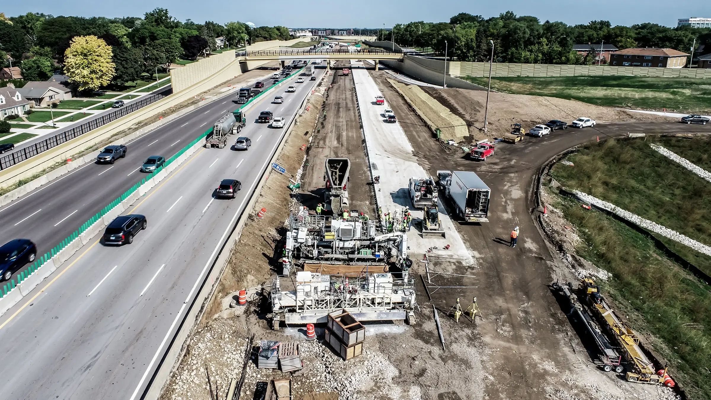A Michels Road & Stone crew operates a pavign machine alongside Interstate 41 near the Zoo Interchange in Milwaukee County