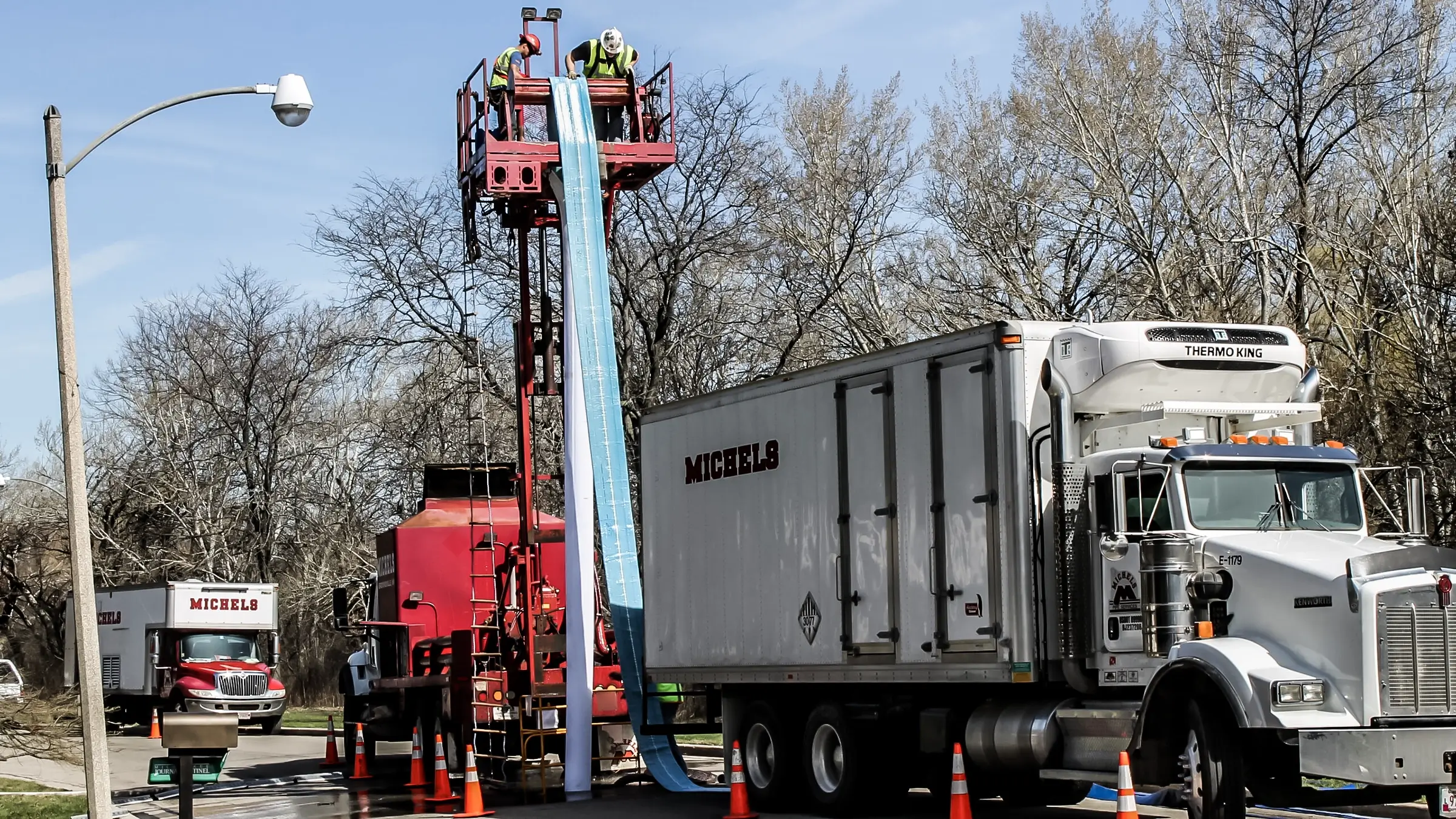 A CIPP liner is lowered into a sewer main using a water column and a hydraulic platform