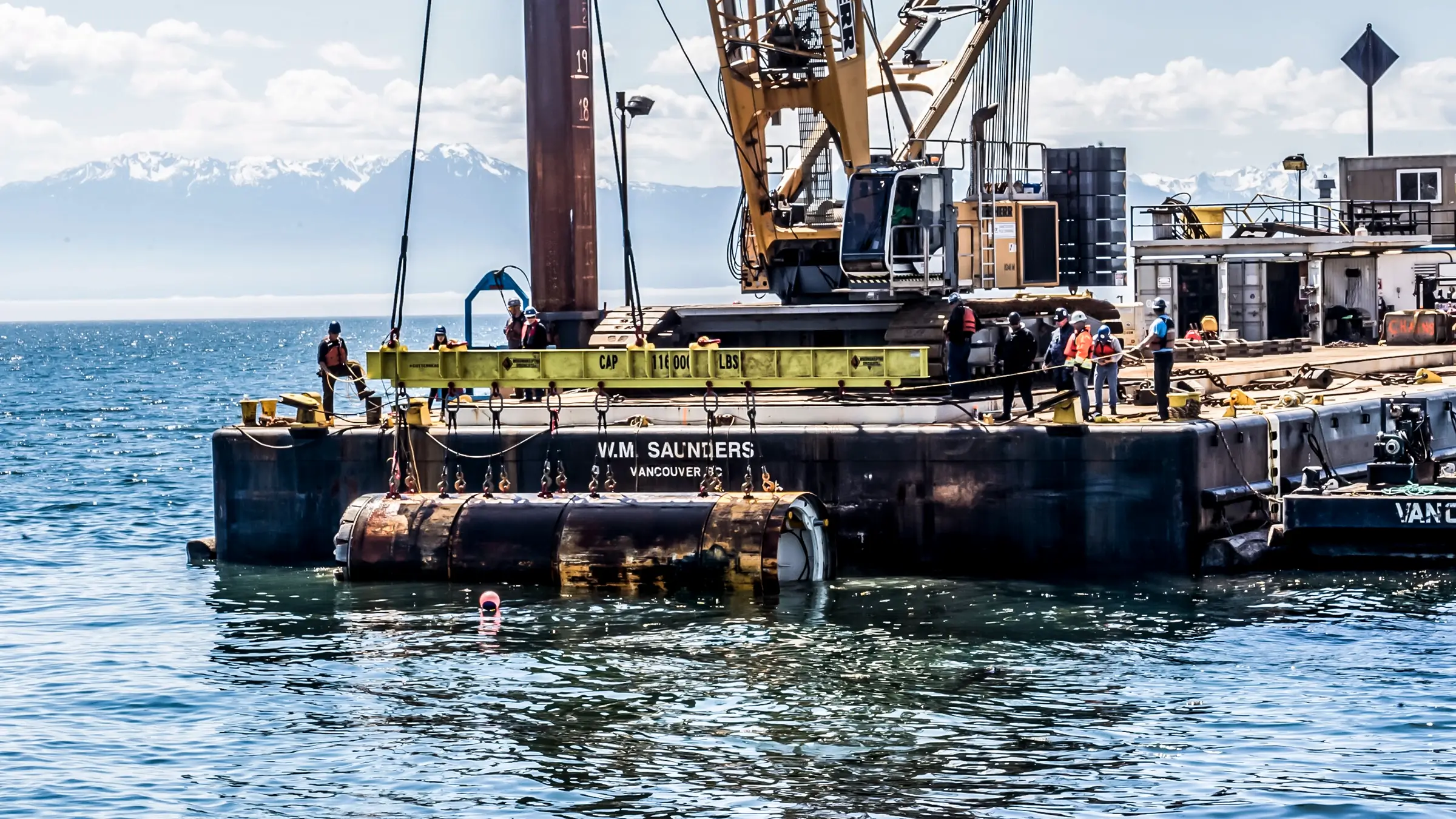 A microtunnel bore machine is lifted out of the ocean after building an ocean outfall