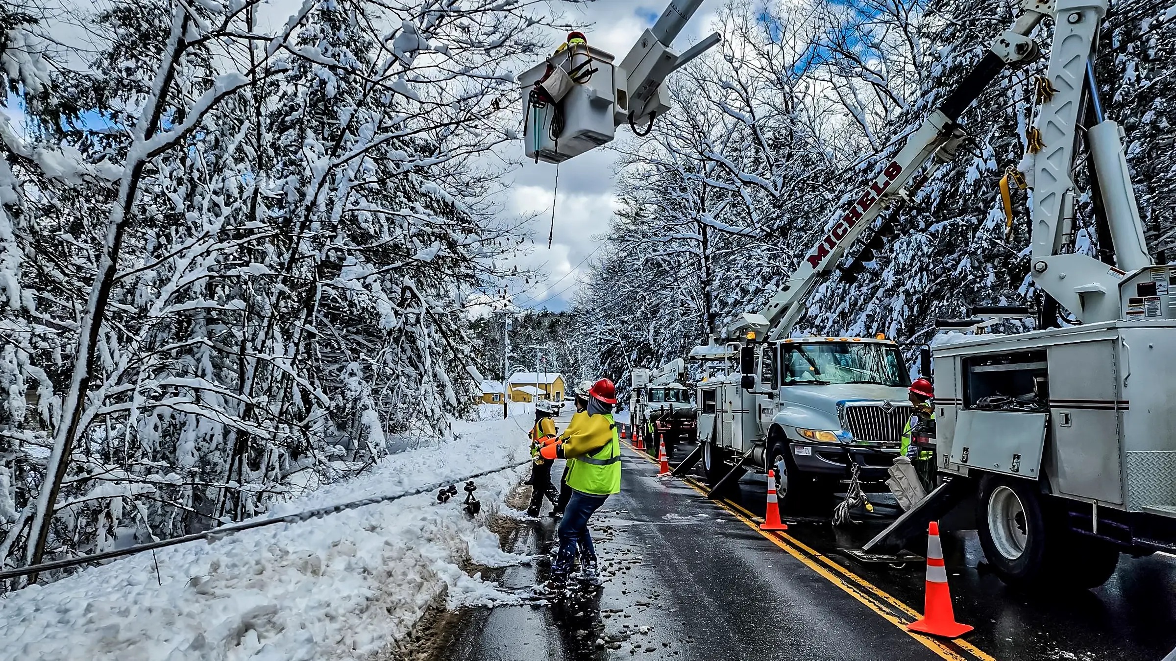 A Michels Canada crew rebuilds a power line after a snowstorm