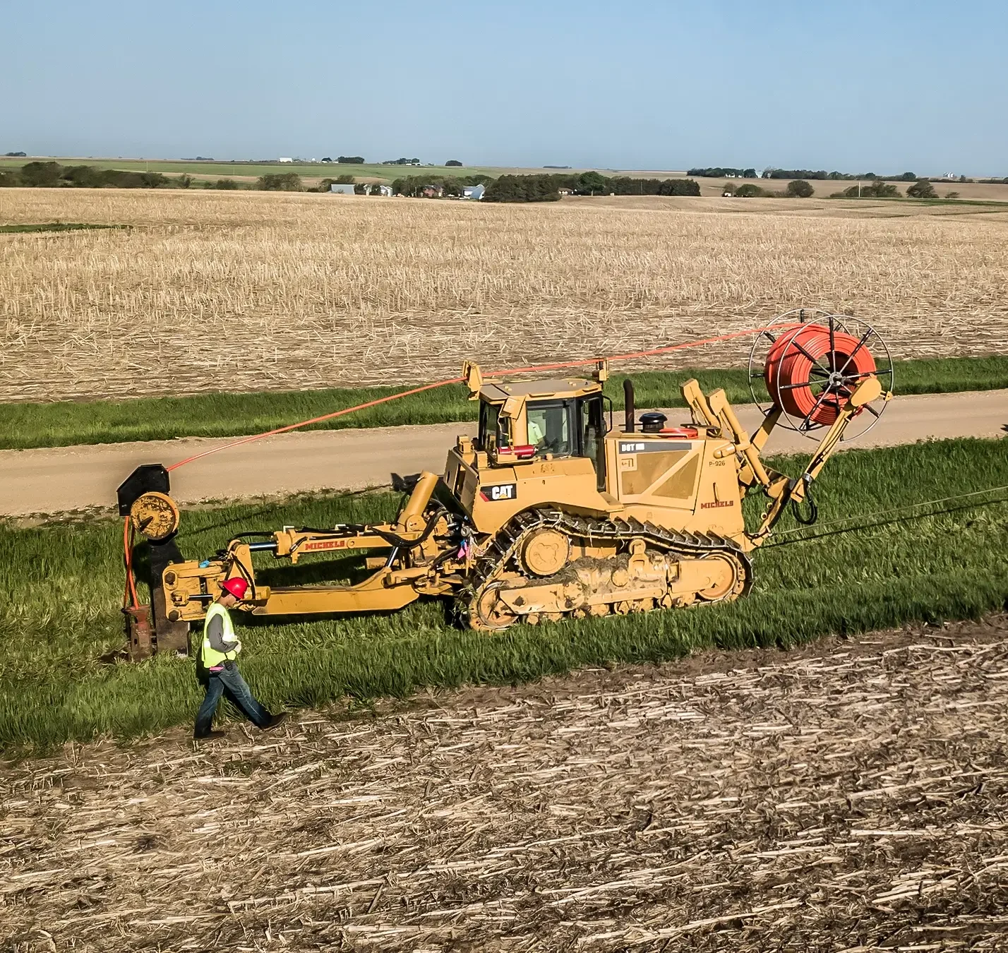 Two plowing machines install underground cable in rural Nubraska.