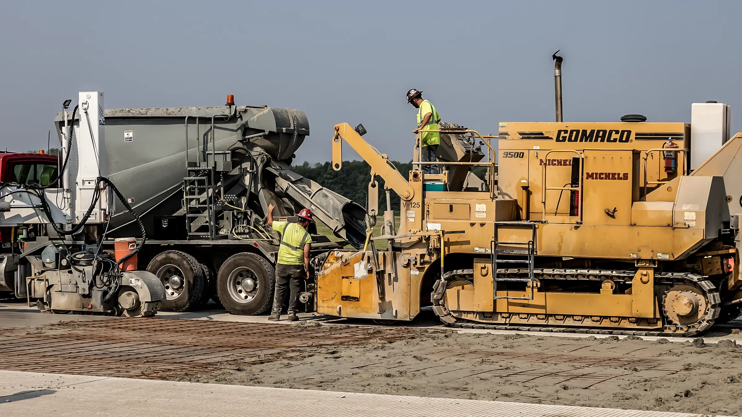 Concrete is loaded into a paving machine on an airport runway in Green Bay.