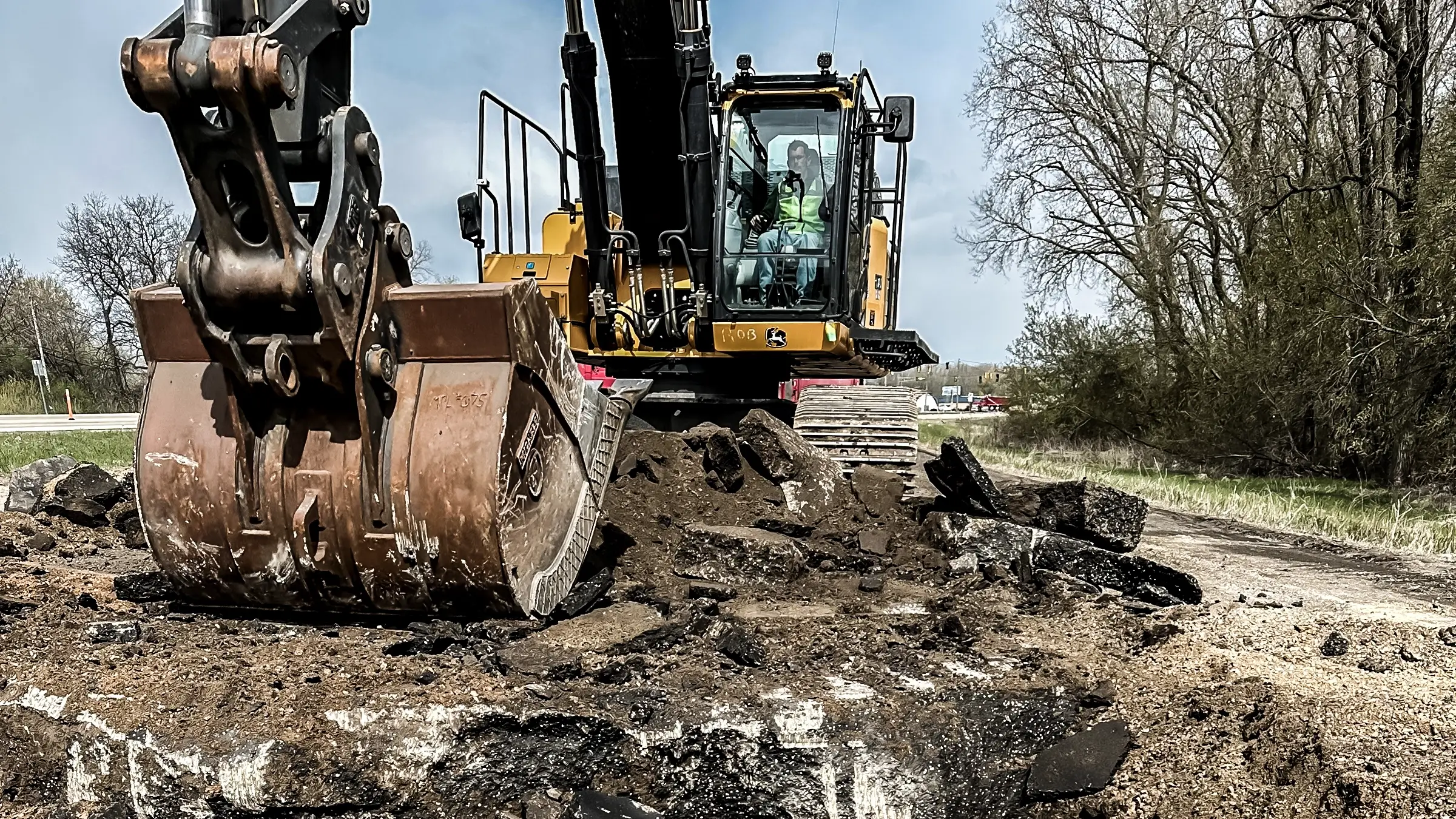 An excavator moves material from the ground.